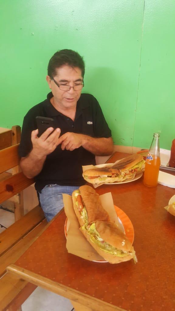 A man sitting at a table with food on it