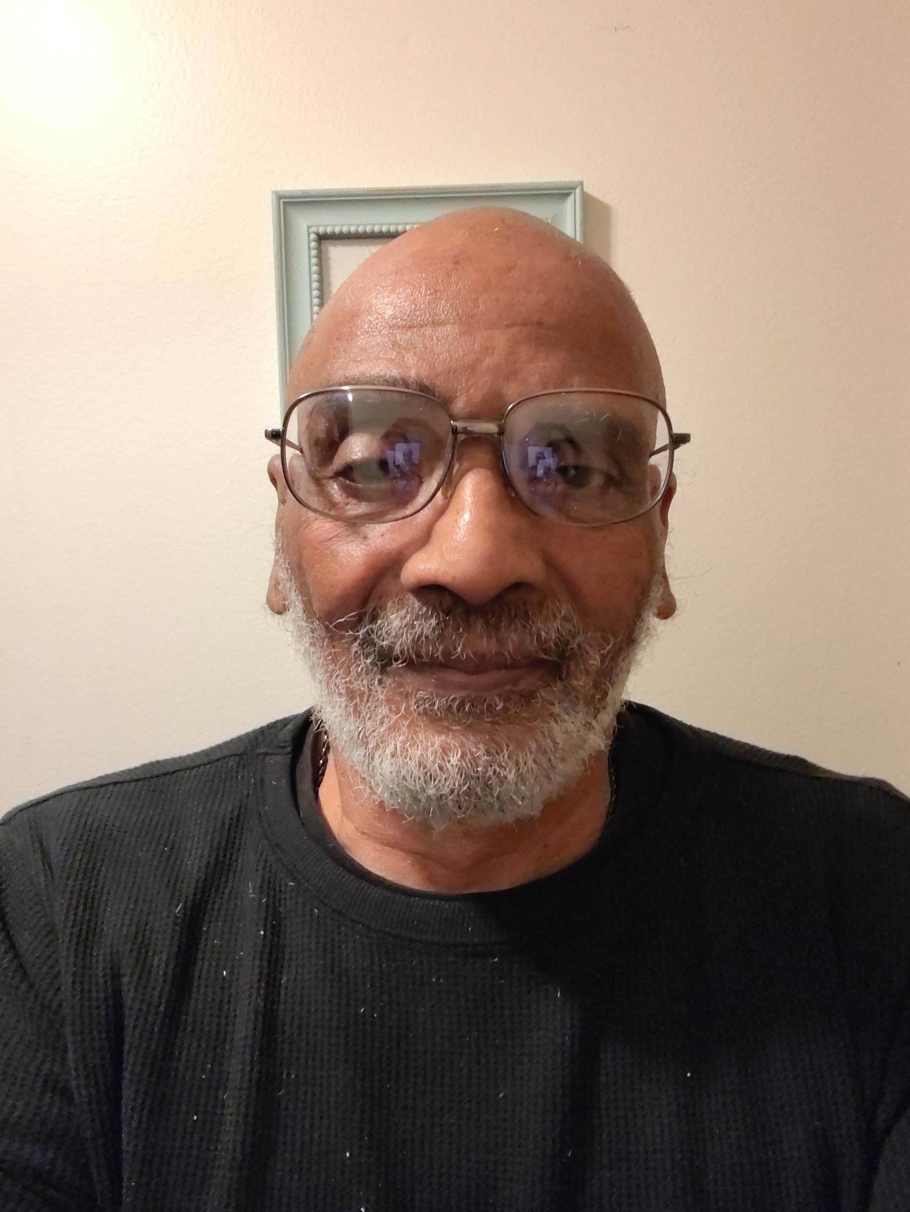 A man with glasses and a beard