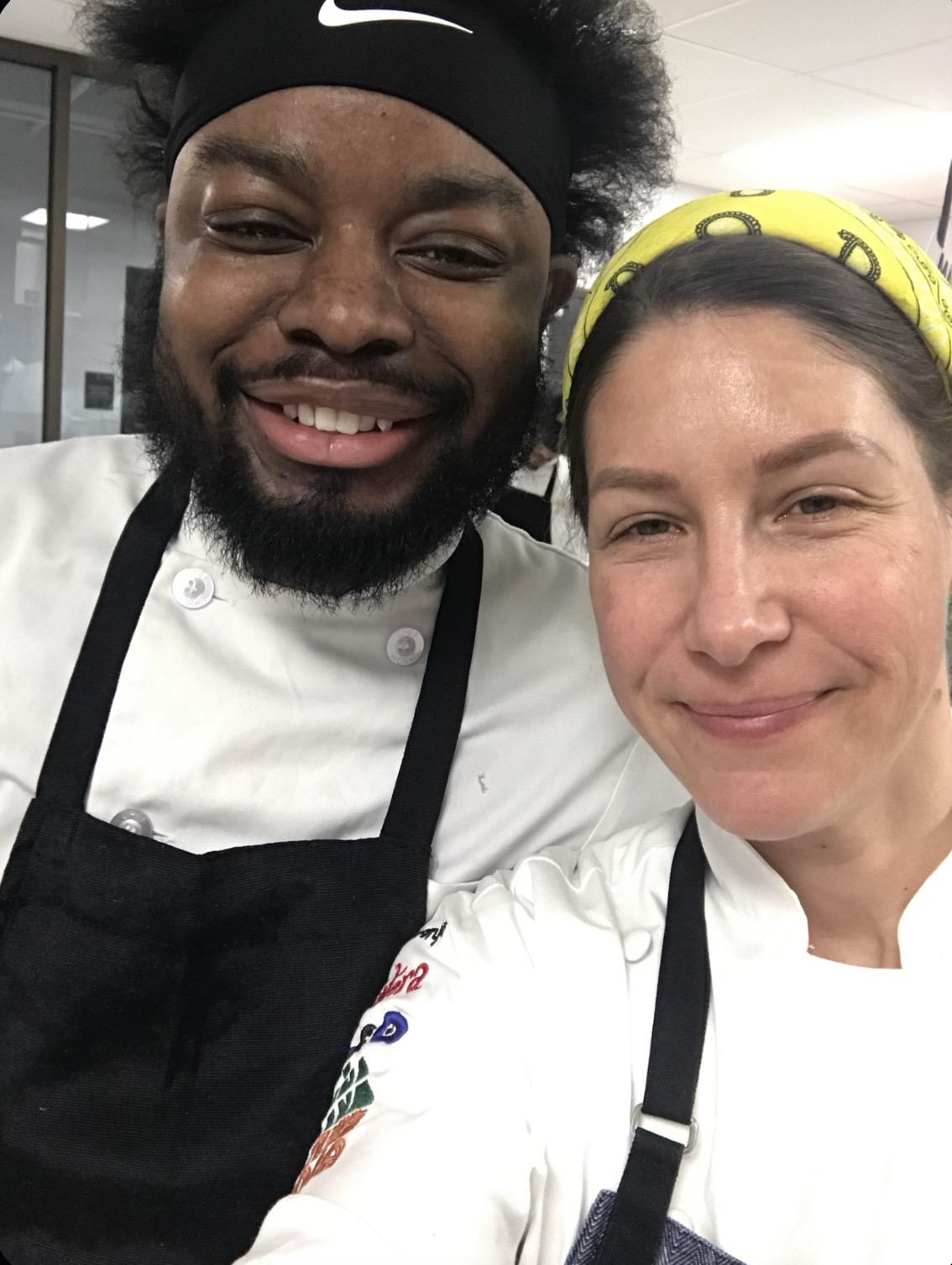 A man and woman wearing aprons