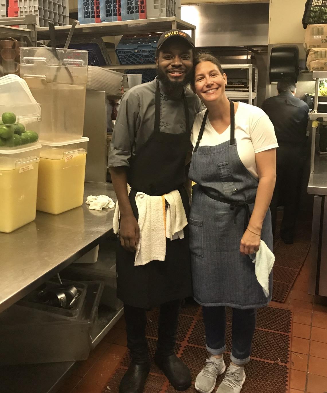 A man and woman standing in a kitchen