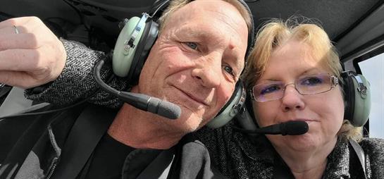 A man and woman wearing headsets