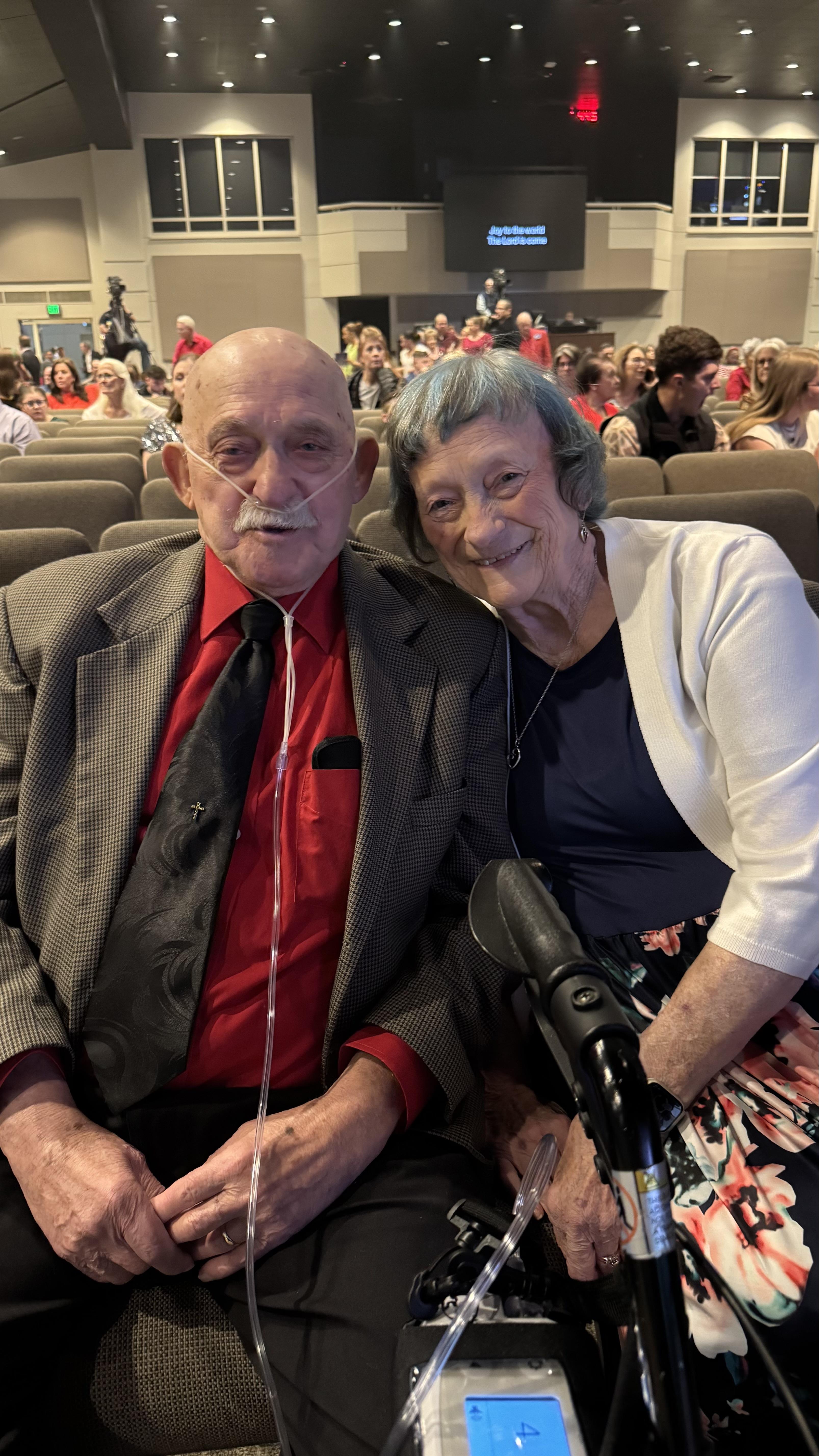 A man and woman sitting in an auditorium