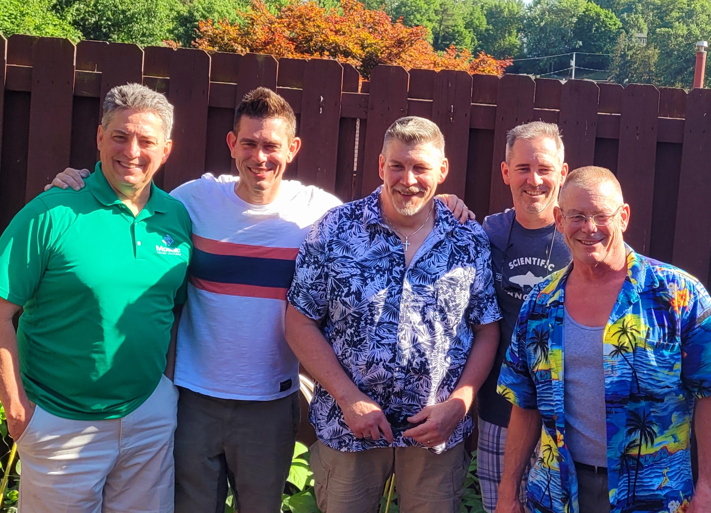 A group of men standing together in a garden
