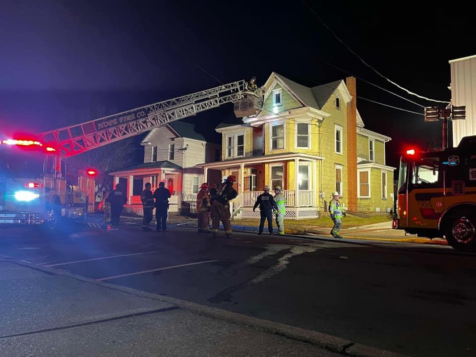 A firefighter standing in front of a house