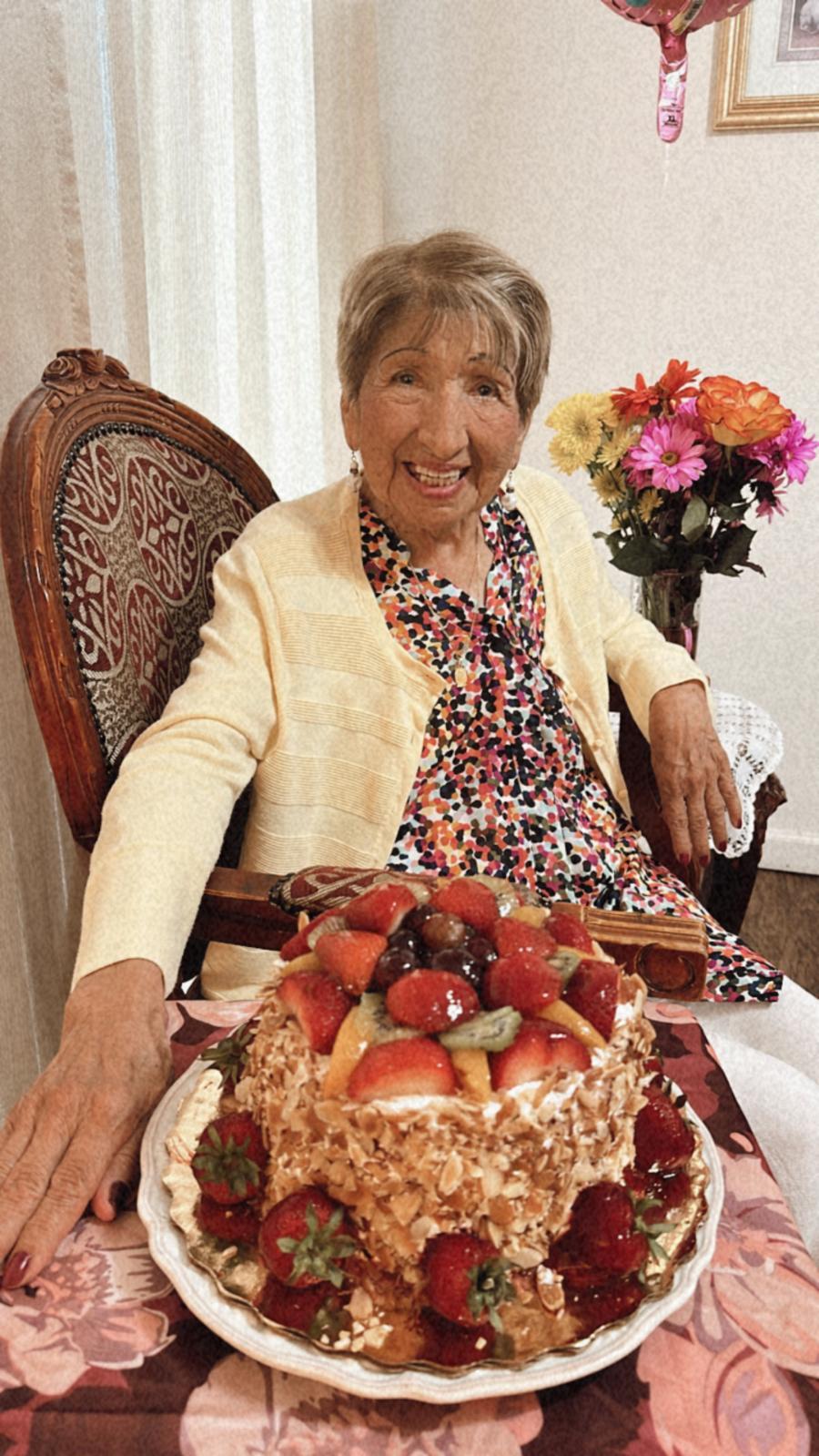 A woman sitting in a chair with a cake