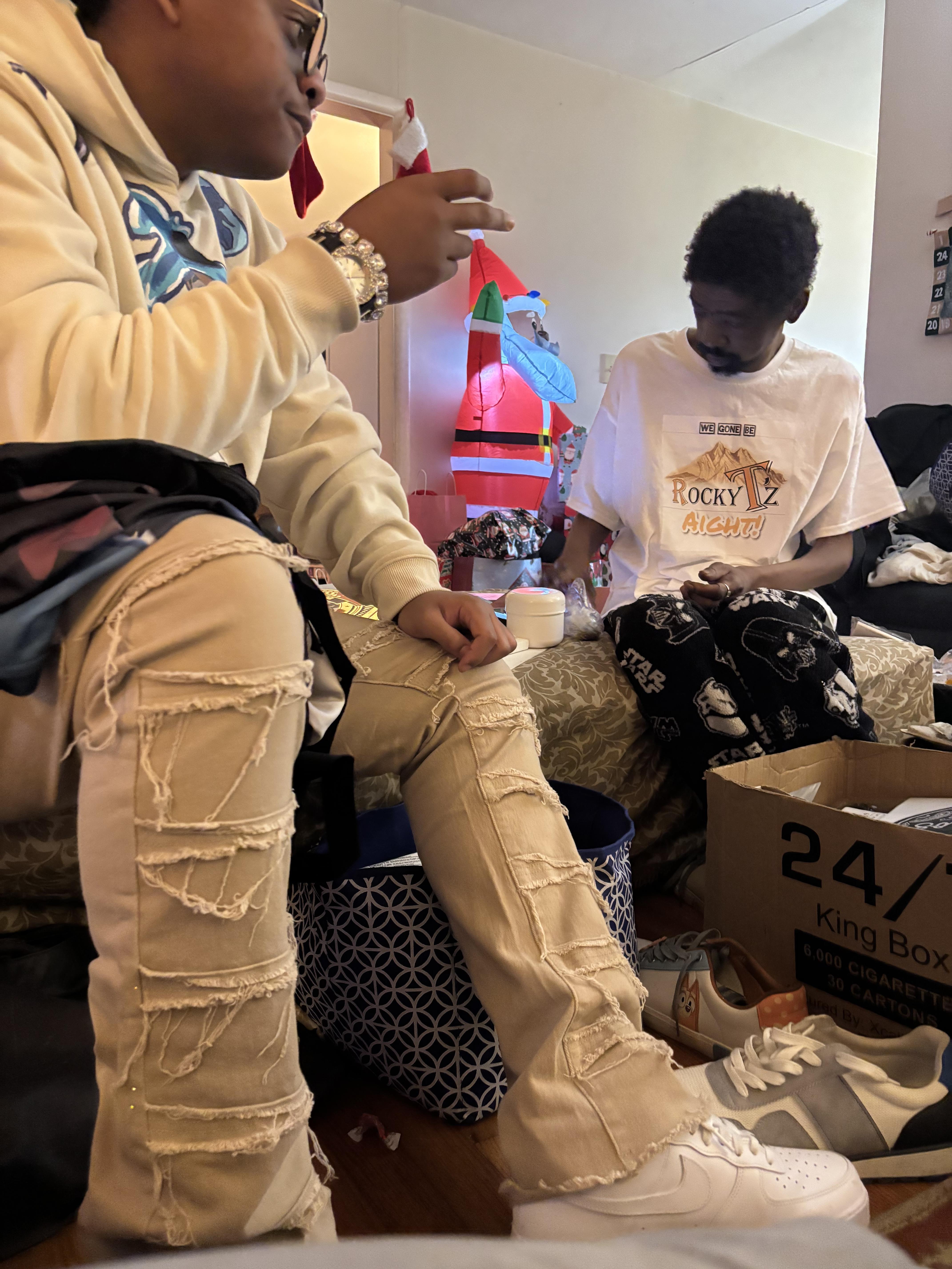 A group of men sitting on a bed