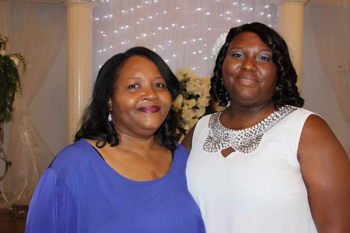 Two women standing together smiling