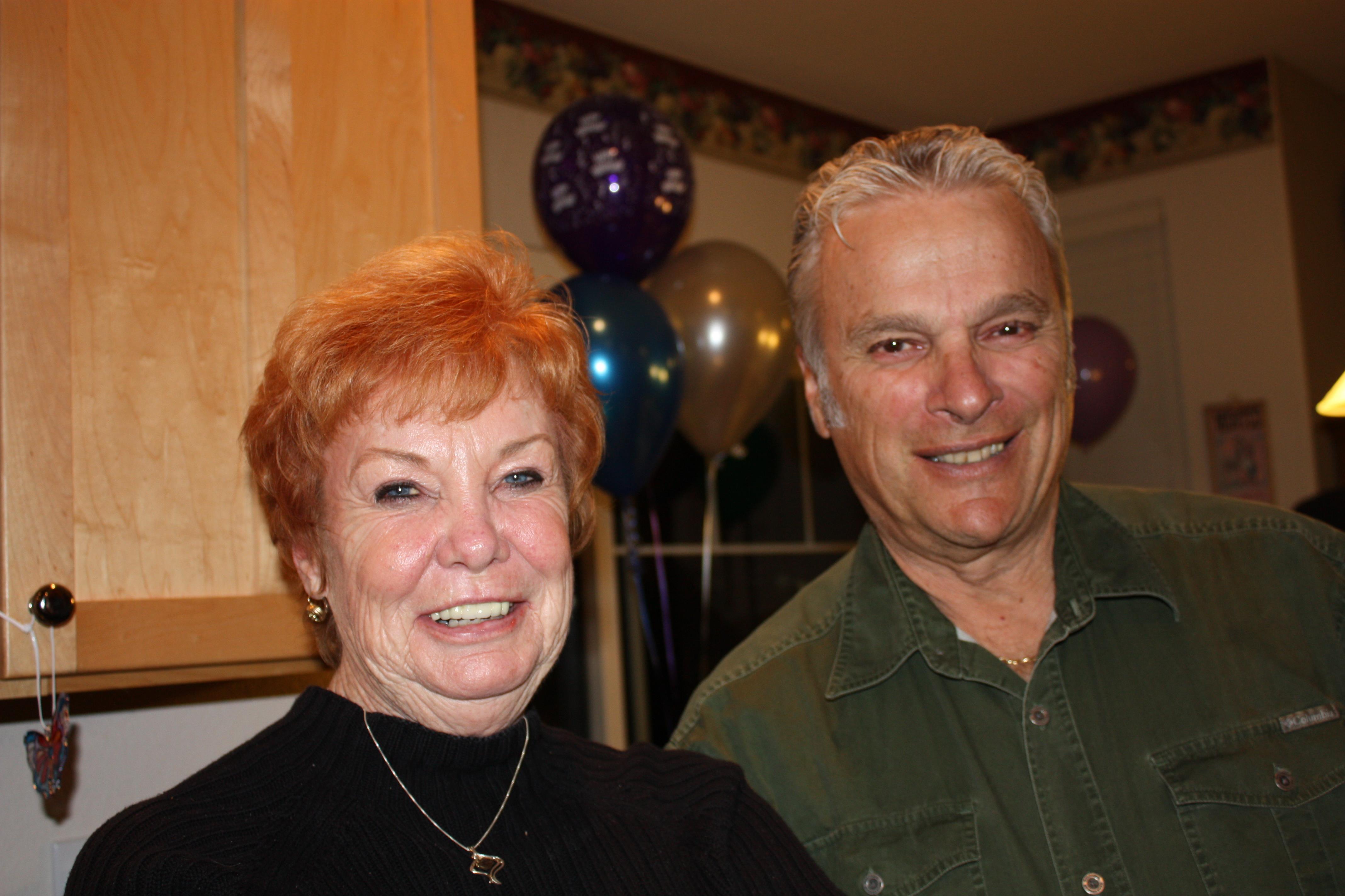 A man and woman smiling at the camera