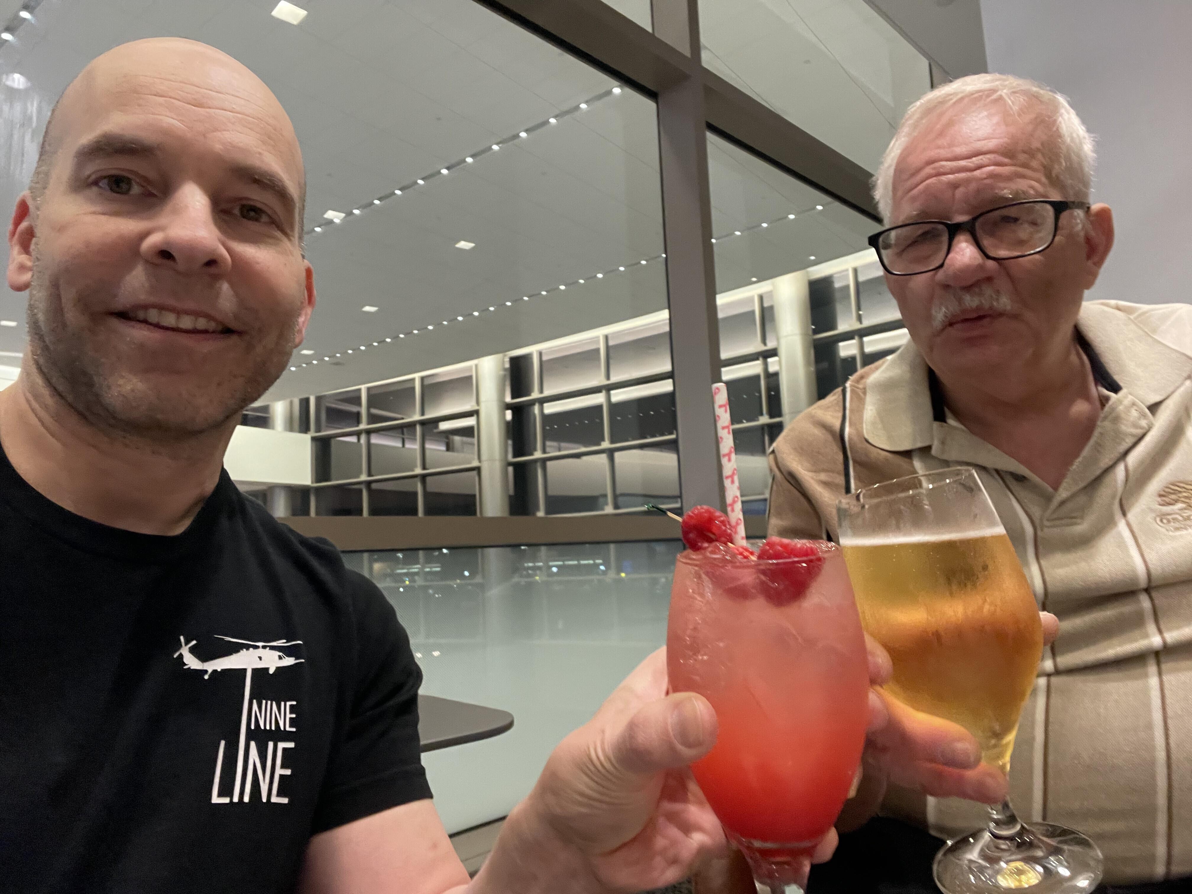 Two men holding drinks
