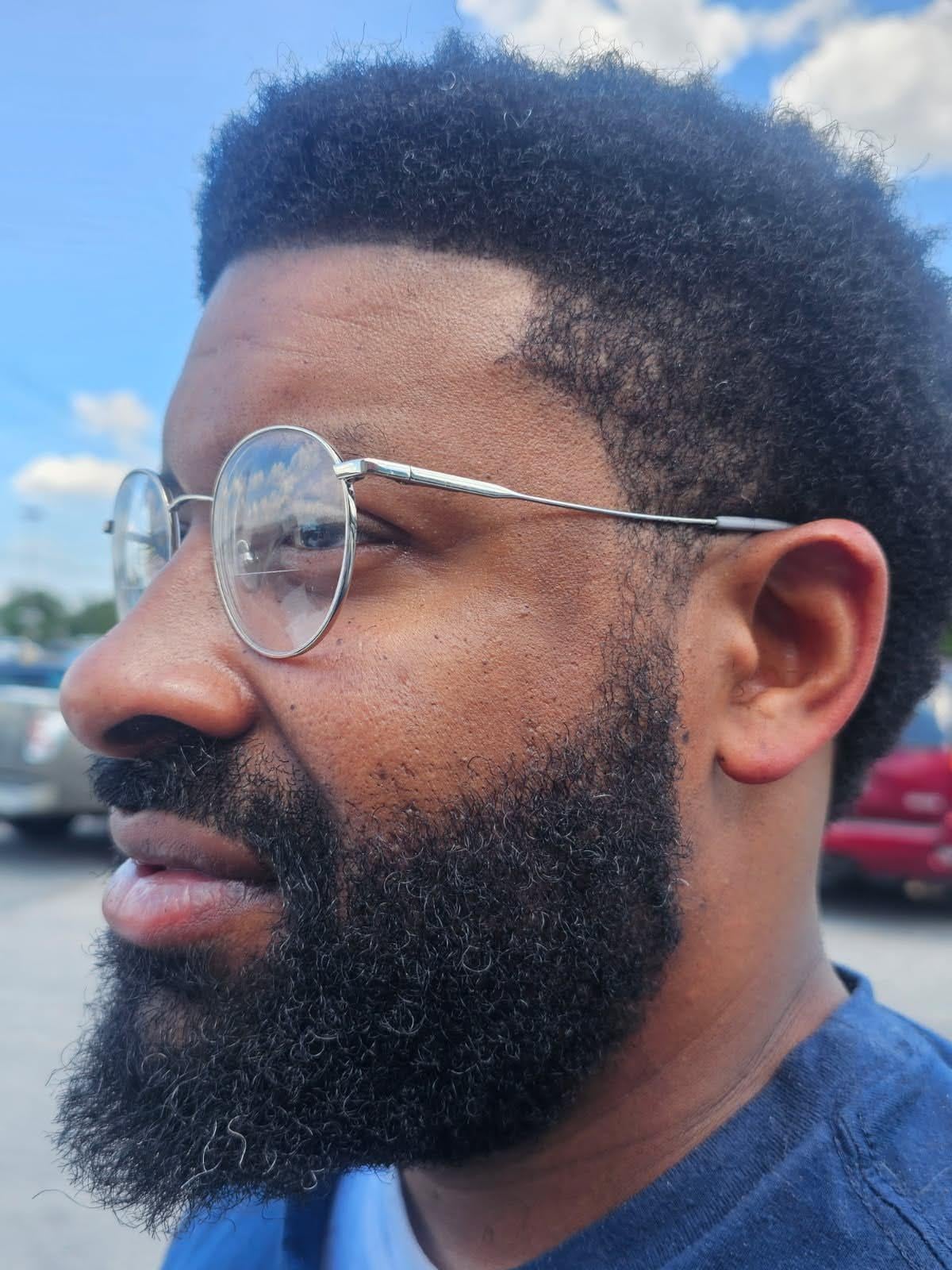 A man with a beard wearing glasses