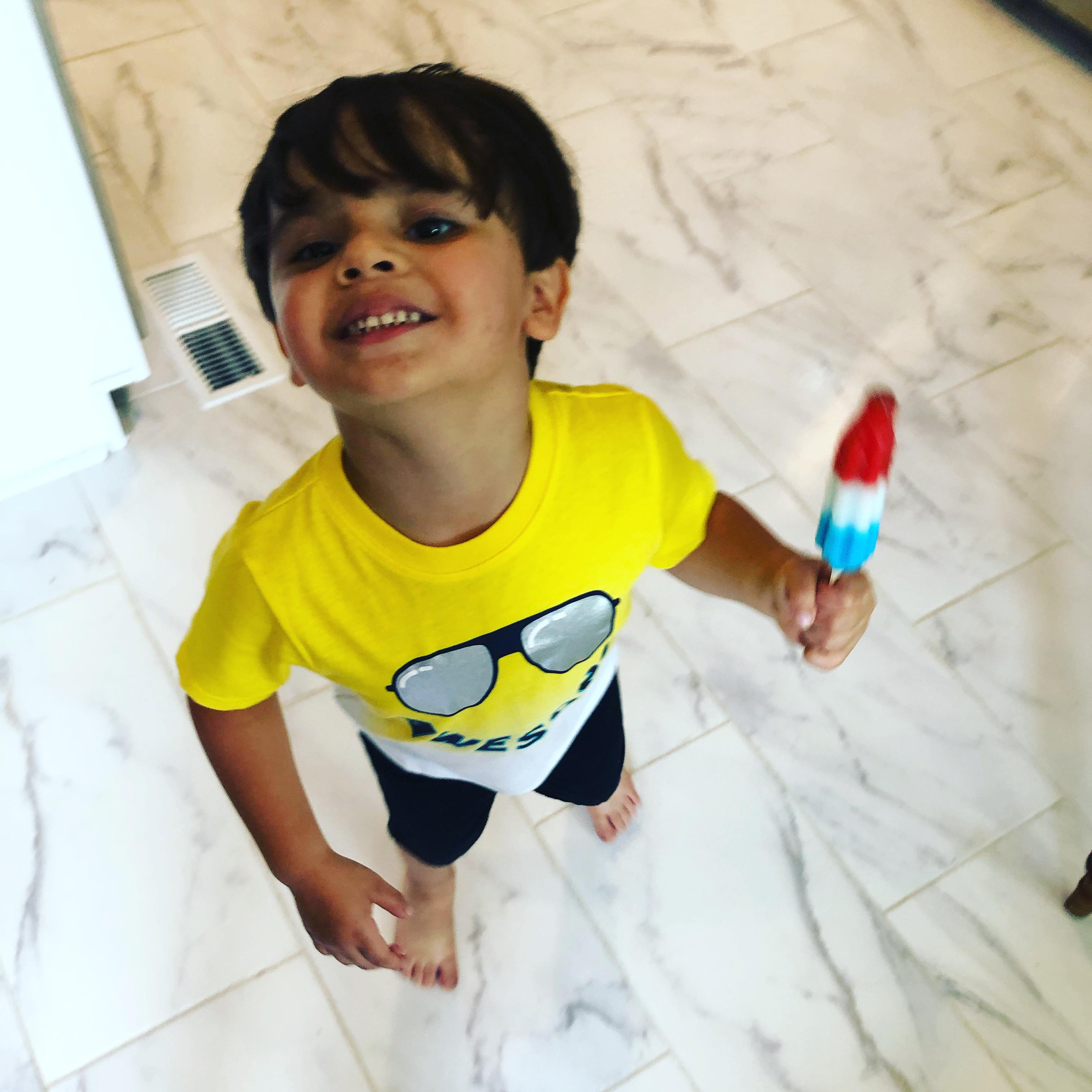 A boy holding a lollipop