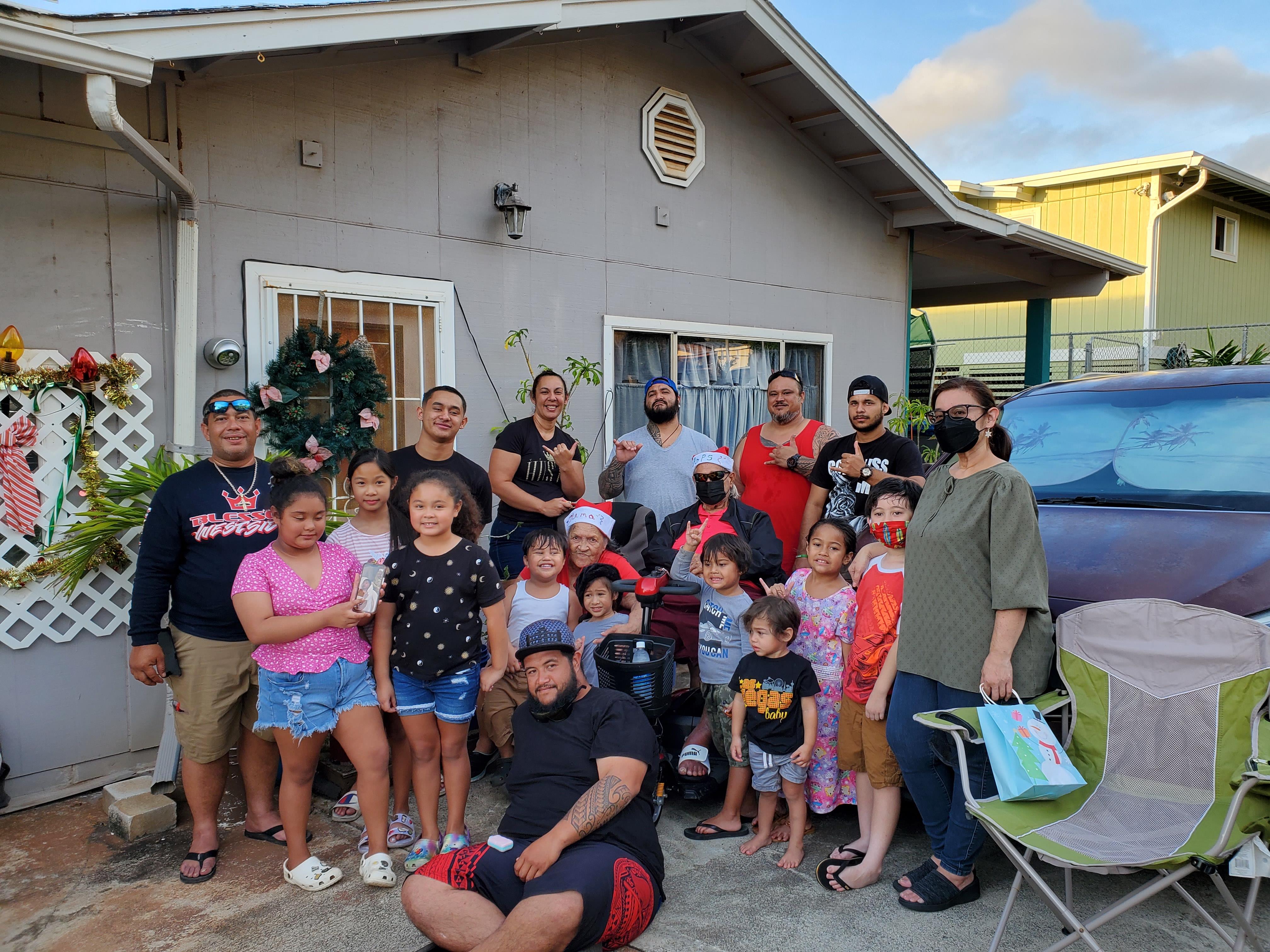 A group of people posing for a photo in front of a house