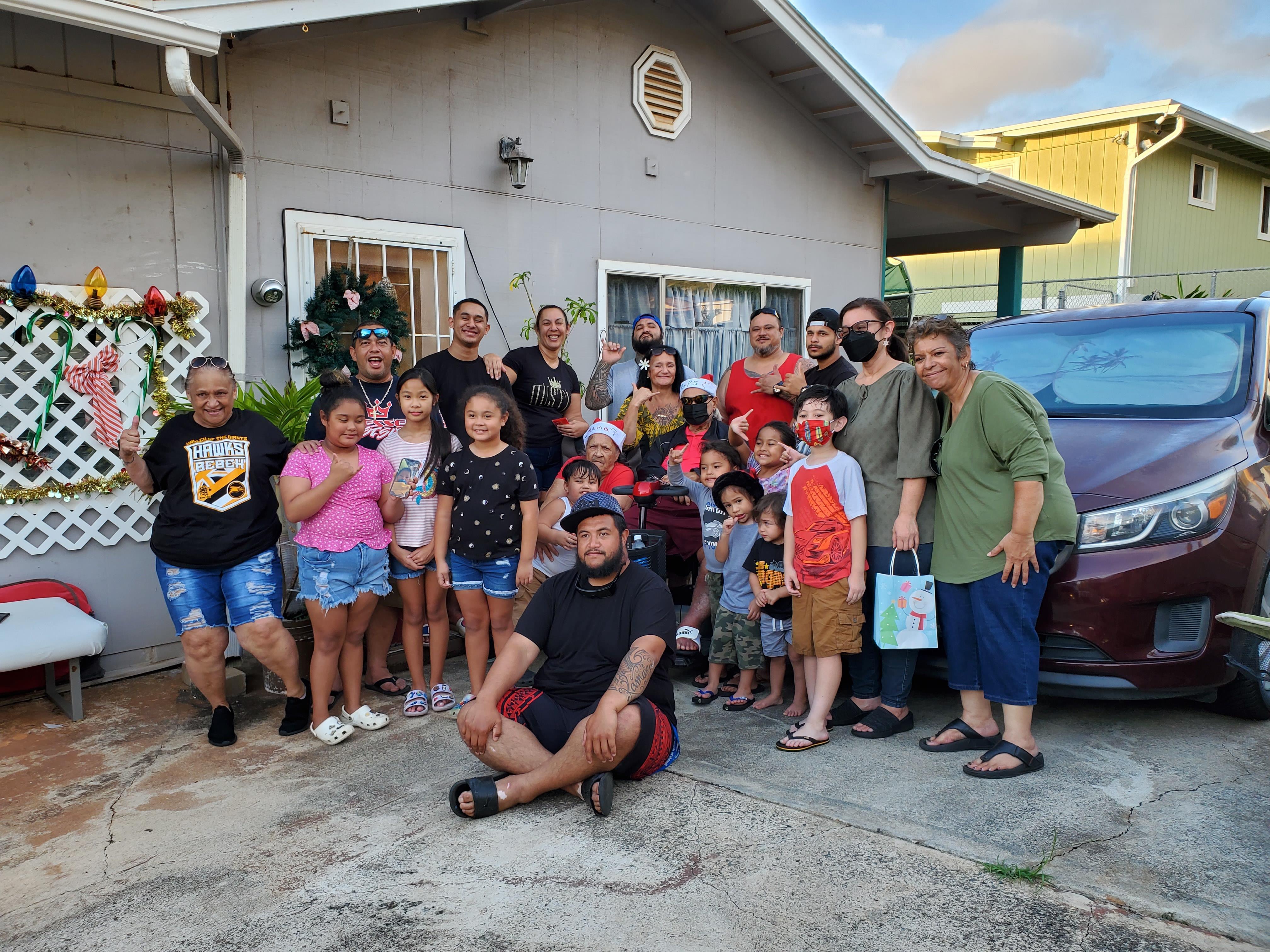 A group of people standing in front of a house