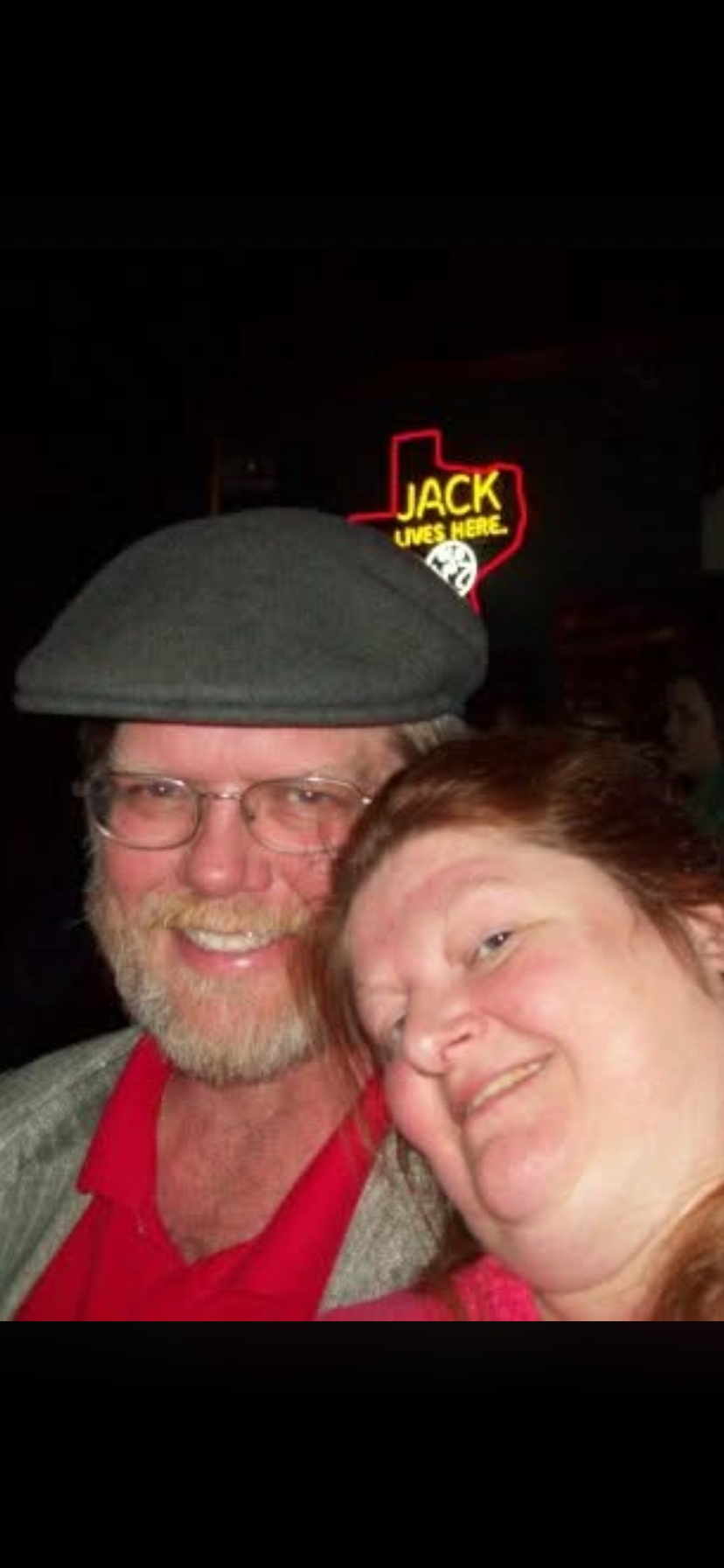 A man and woman smiling at the camera