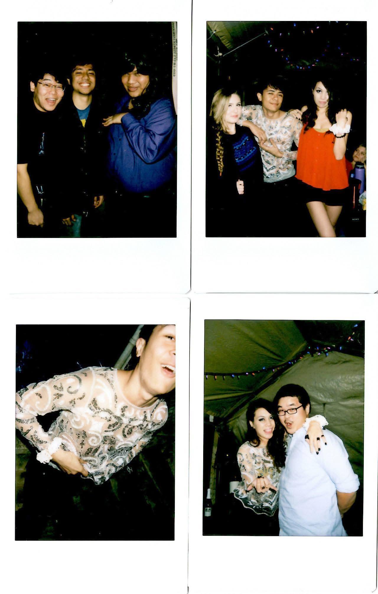 People enjoy a party, taking pictures and interacting with each other under the lights.