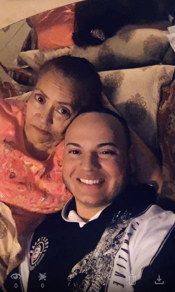 Two people relax on a couch, sharing smiles and enjoying each other's company in a warm home.