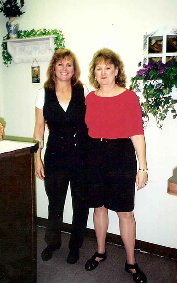 Two women standing together in a room