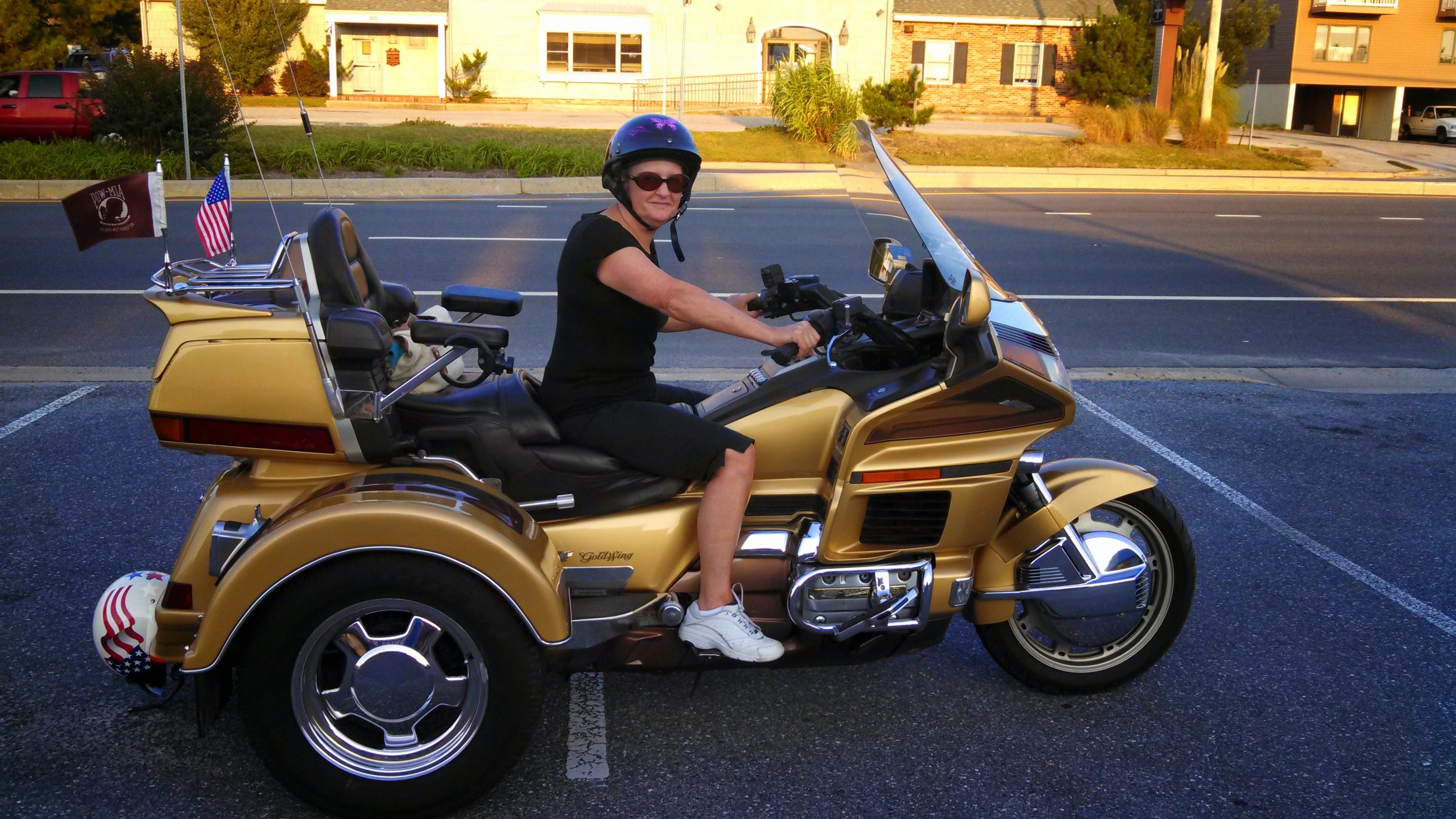 A woman on a gold motorcycle