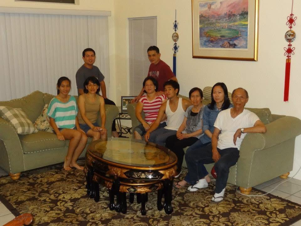 People sit together in a living room, chatting and enjoying each other's company at night.