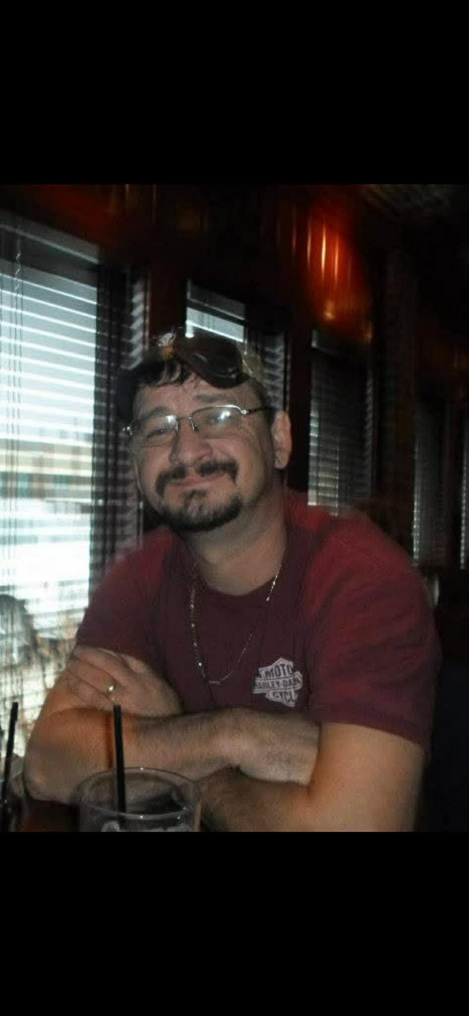 A man with a mustache and glasses