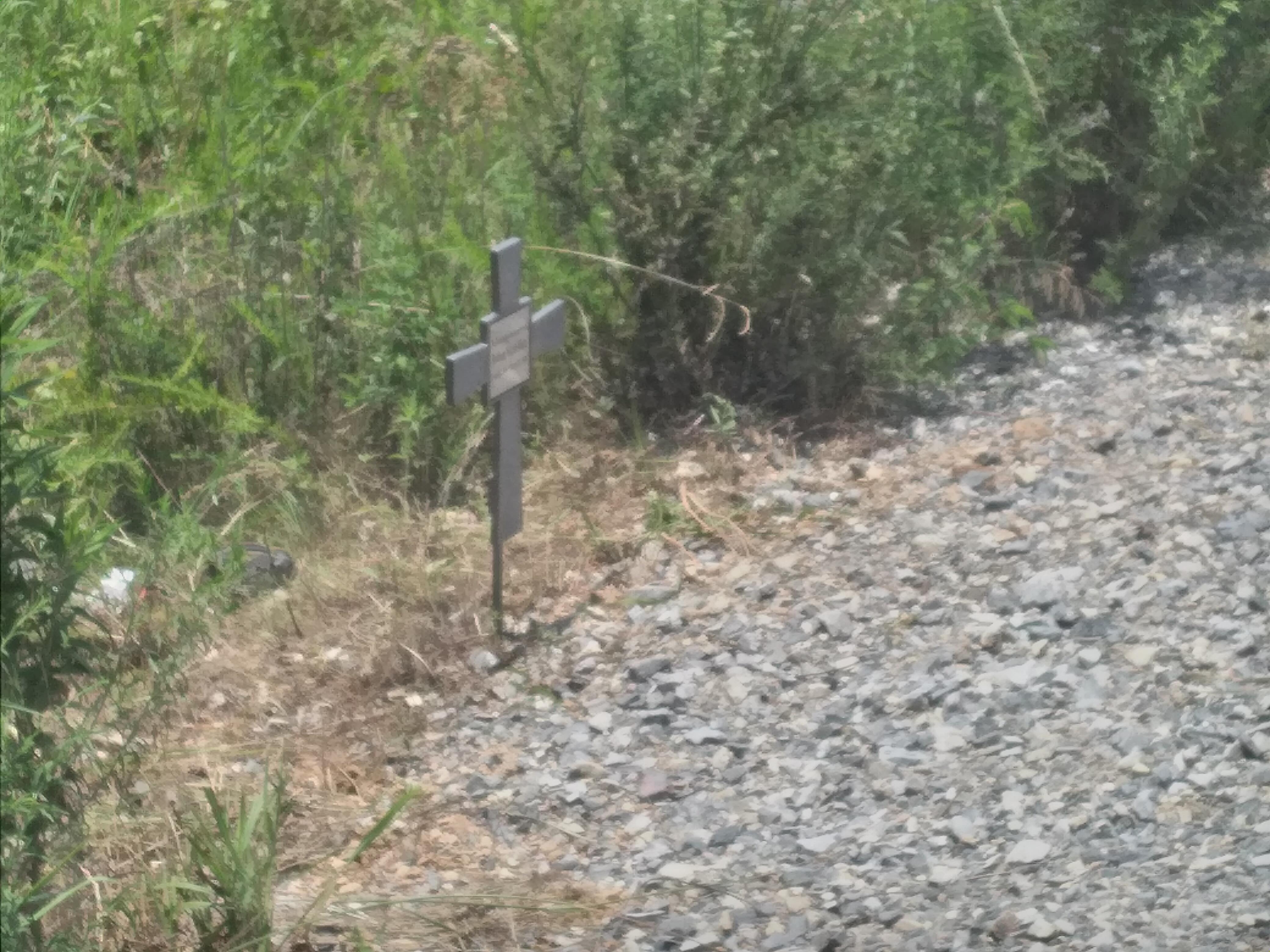 A cross on a gravel path