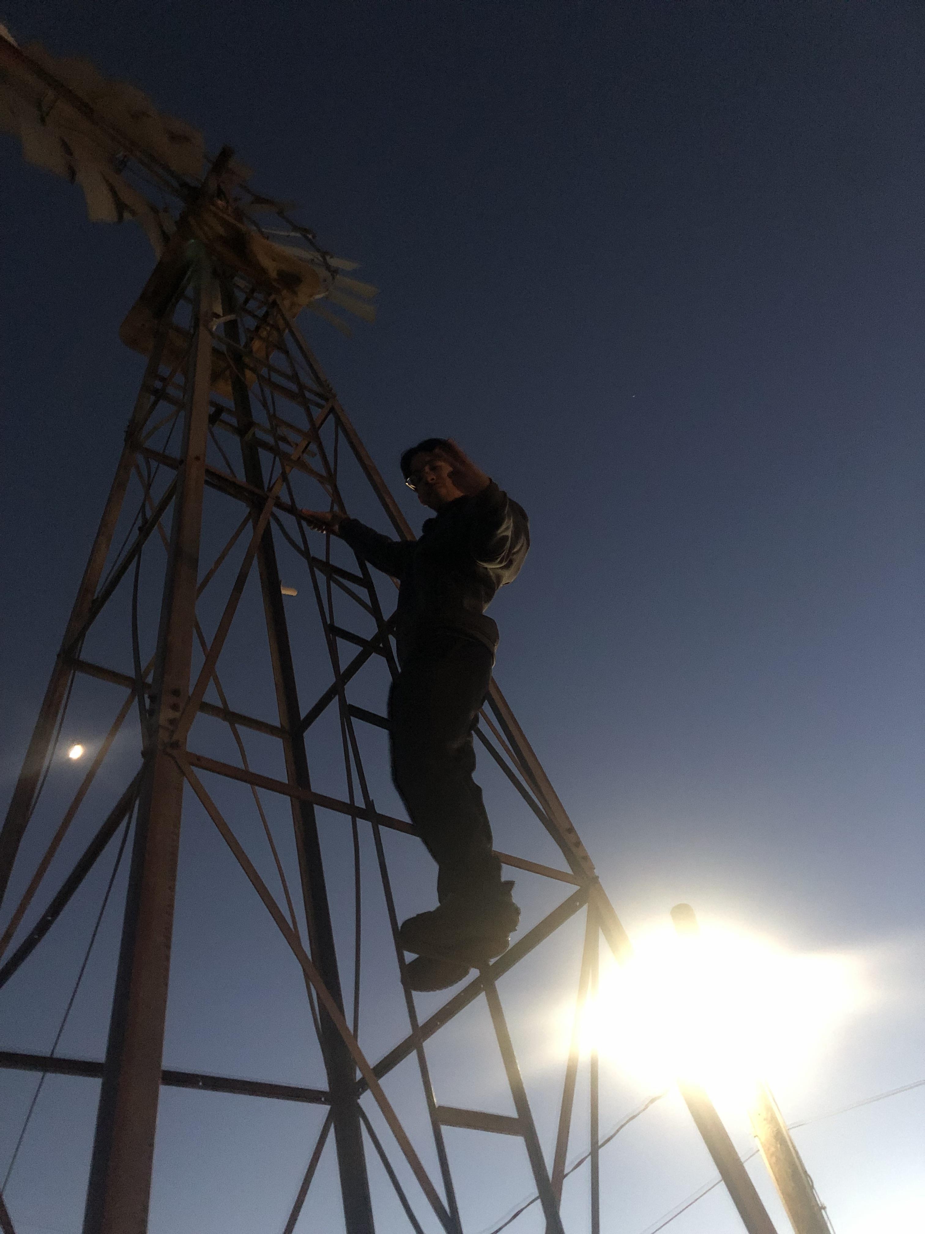 A man climbing a windmill
