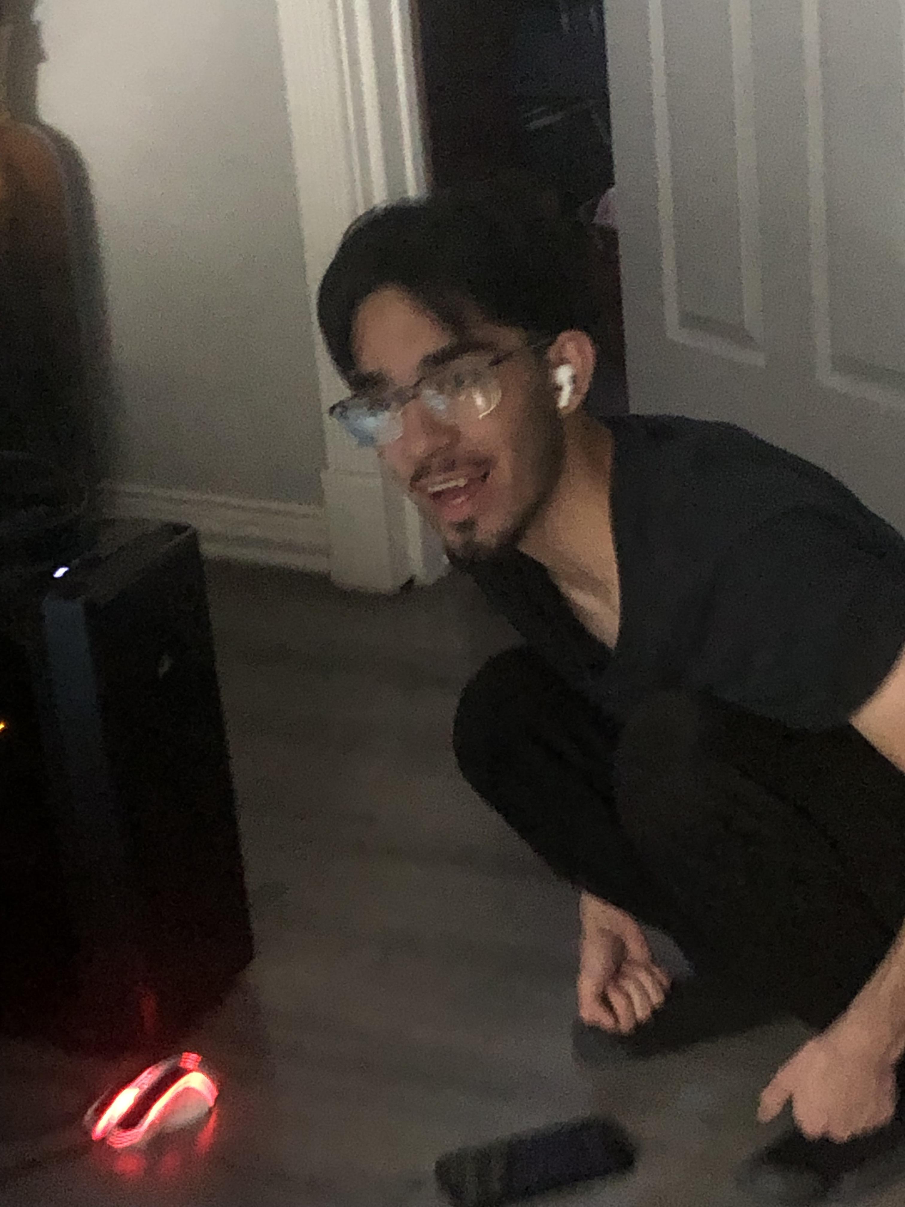 A man squatting on the floor