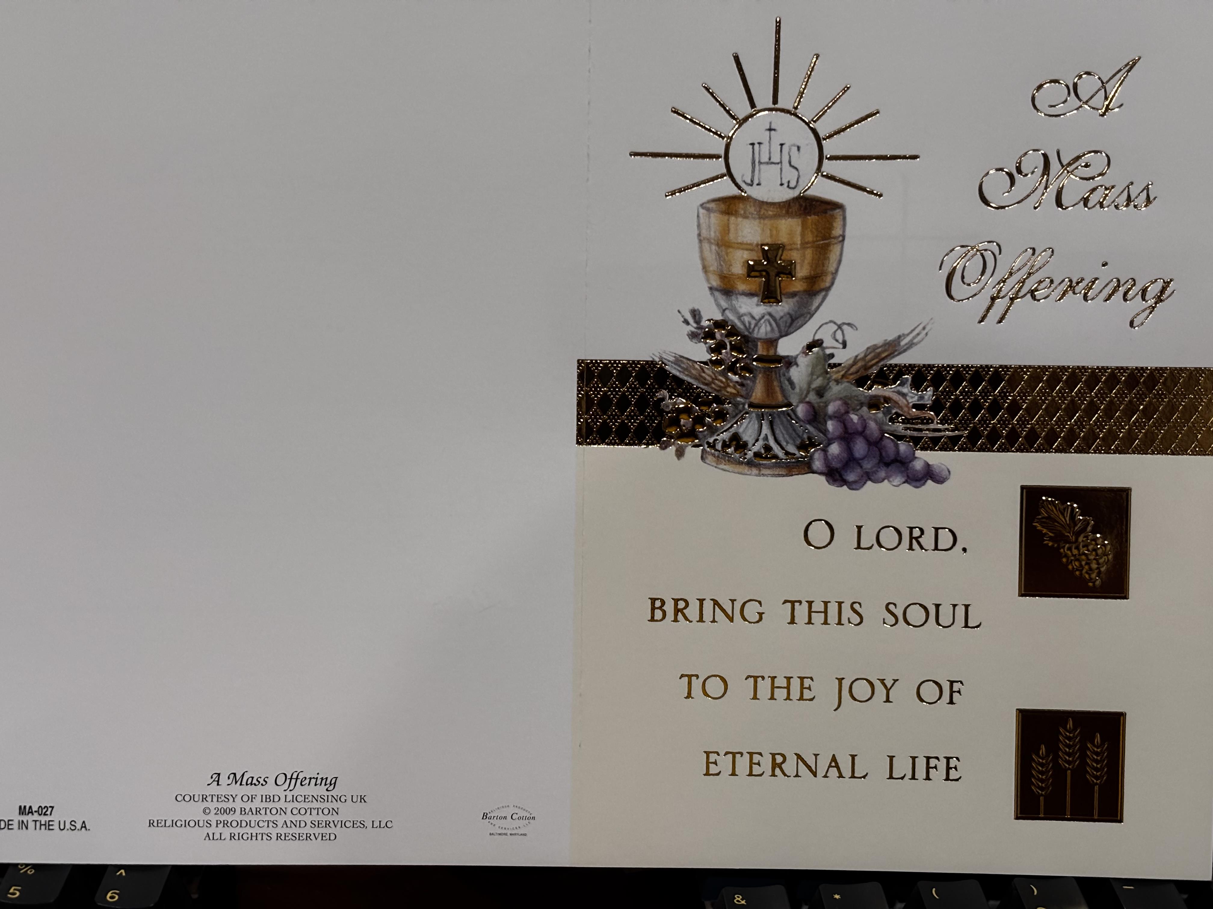 A white card with a picture of a chalice and grapes