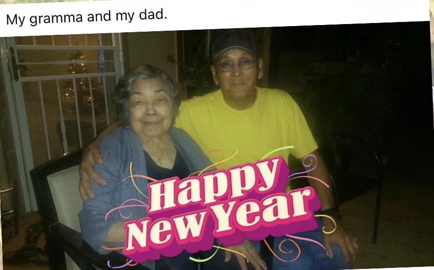 A woman and a man sit together smiling, celebrating New Year. They appear happy and close.