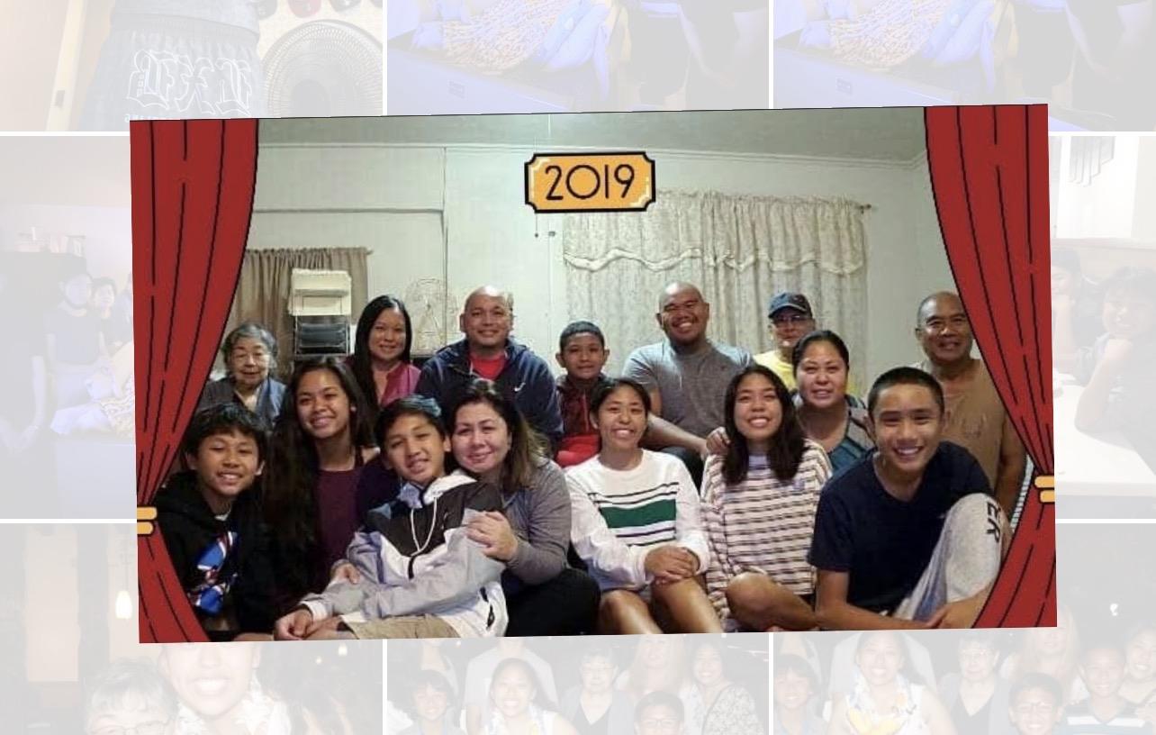 Group of family members smiles together in a living room setting during a reunion in 2019.