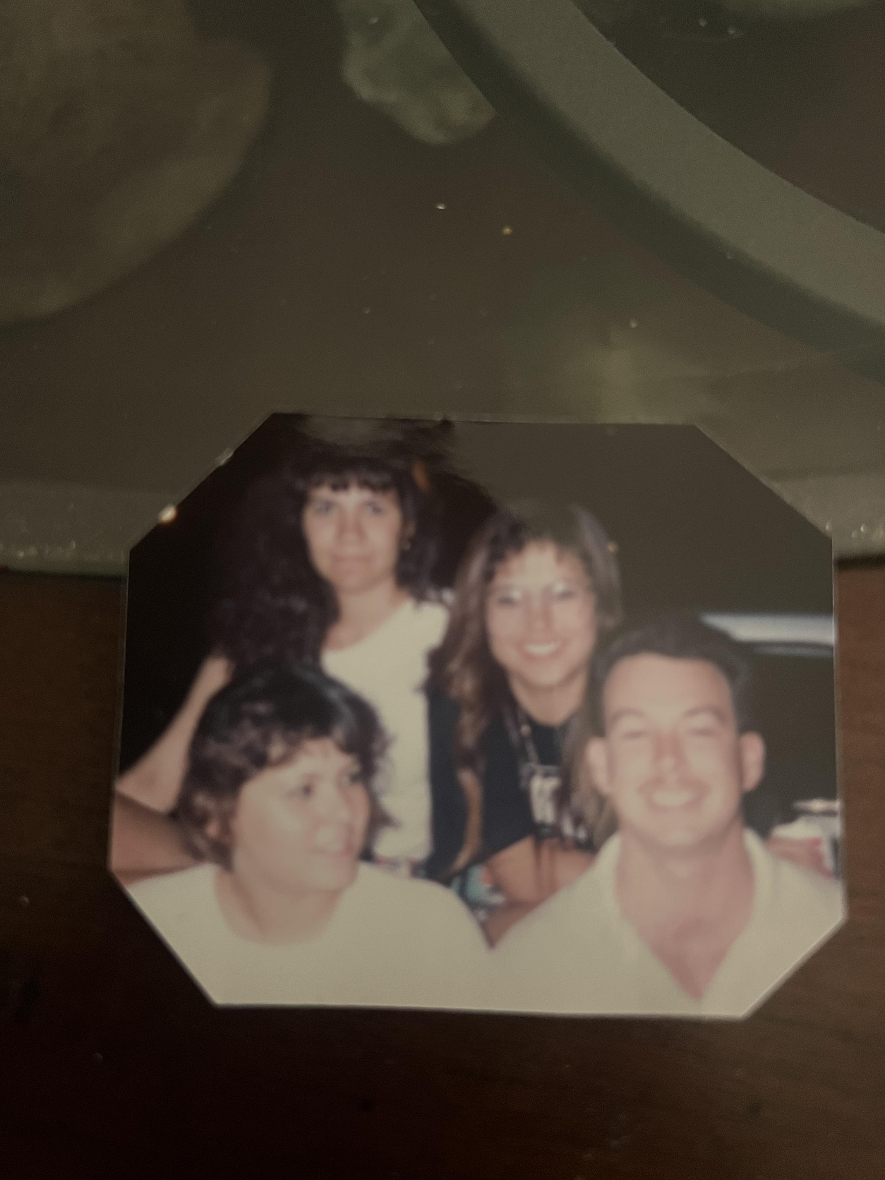 Four people pose together at a table, enjoying their time and sharing smiles during a dinner.