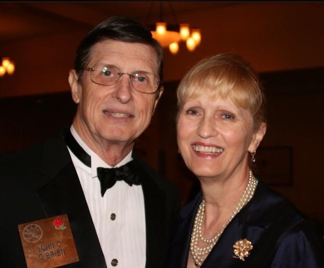 A couple poses for a picture at a formal event.