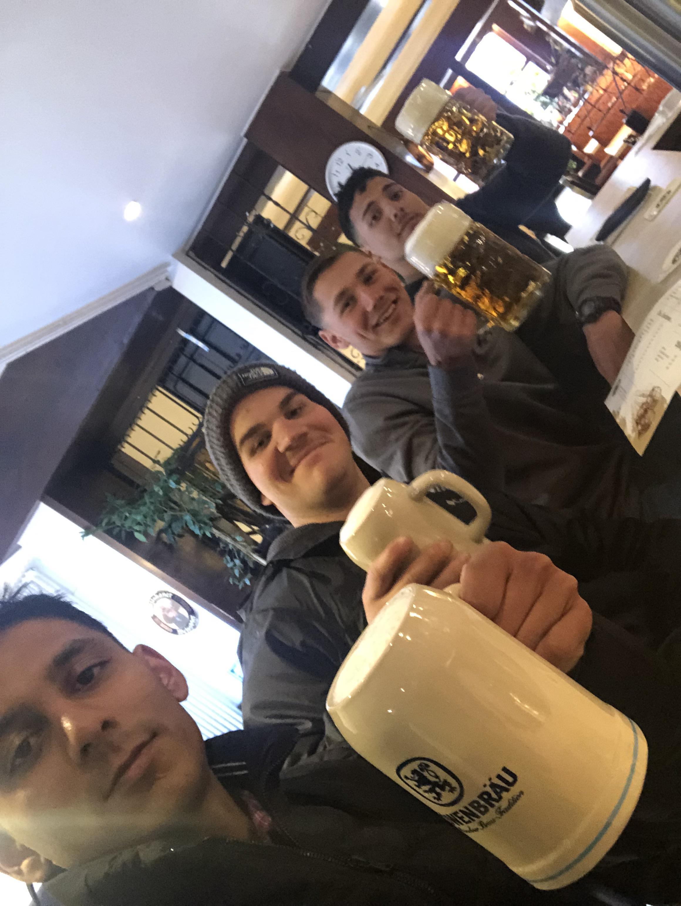 A group of men holding mugs of beer