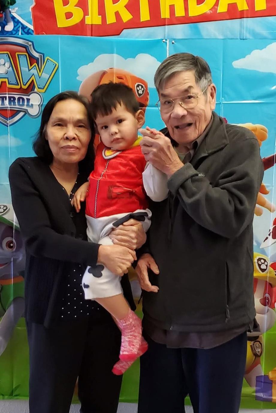 A man and woman holding a child