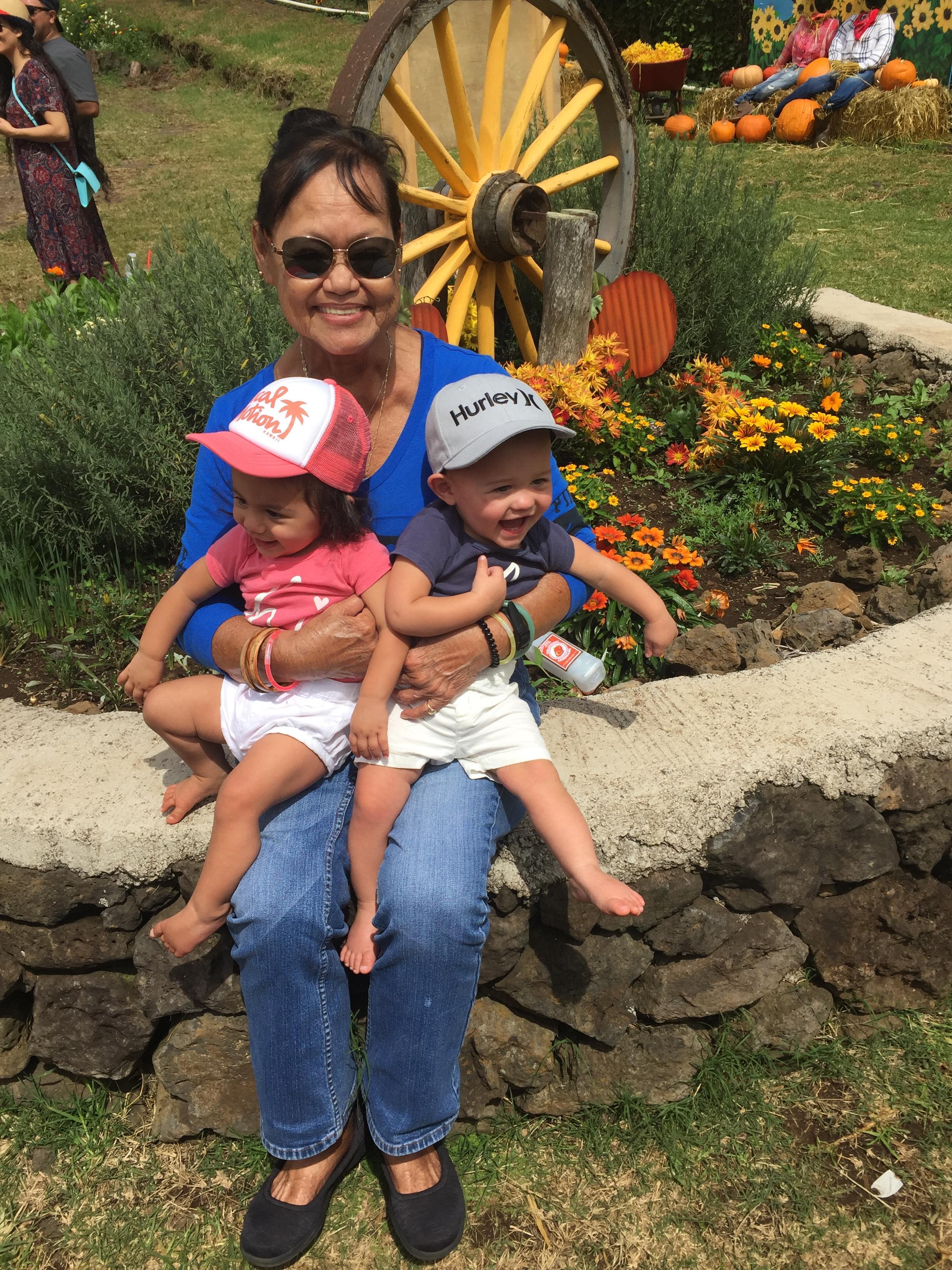A woman holding two children
