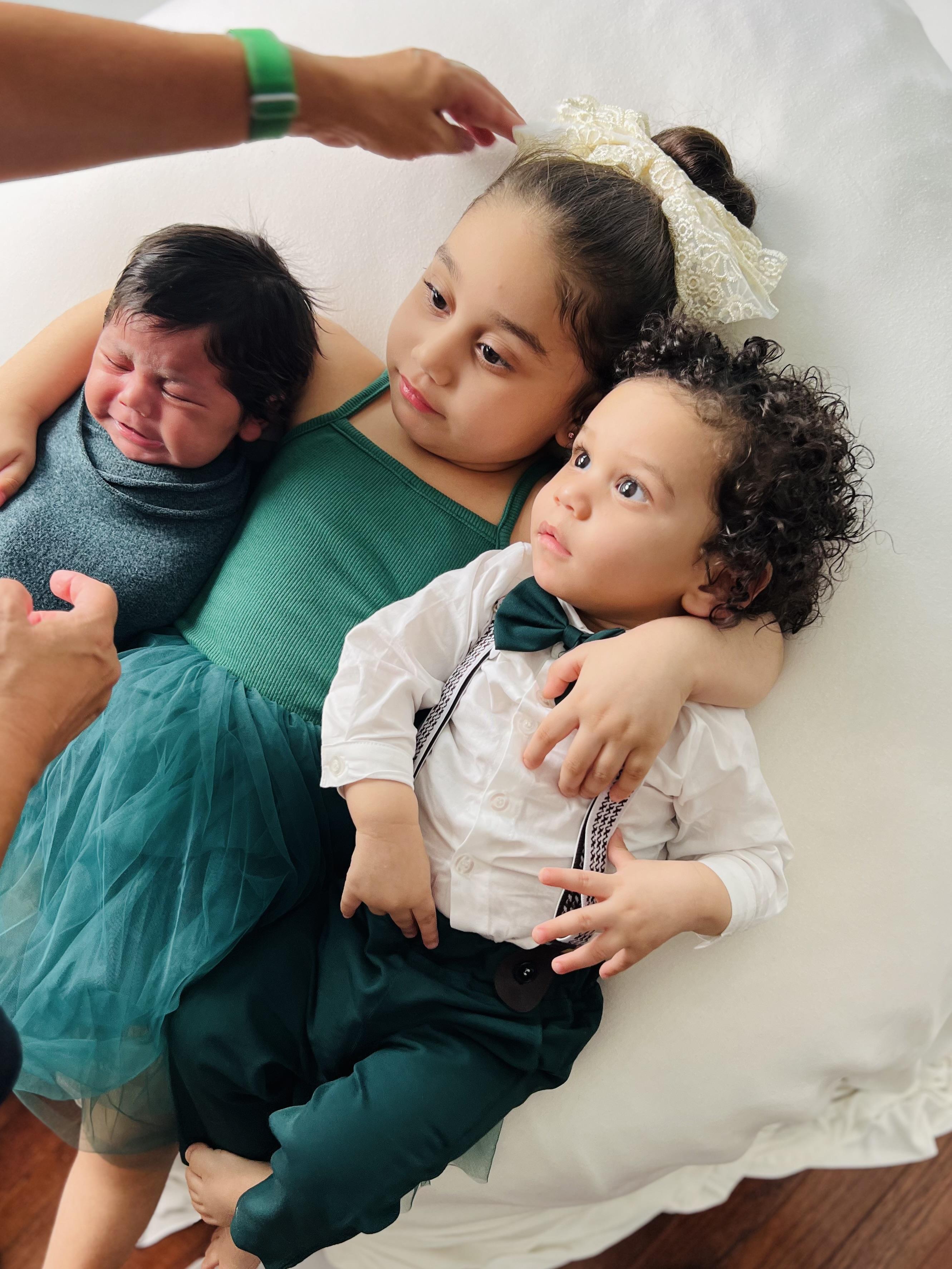 A group of children lying on a white surface