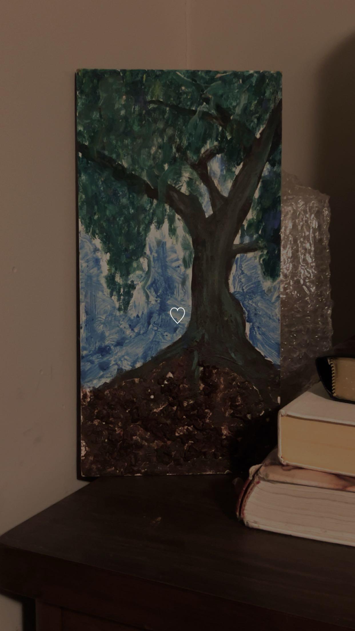 A painting of a tree next to books
