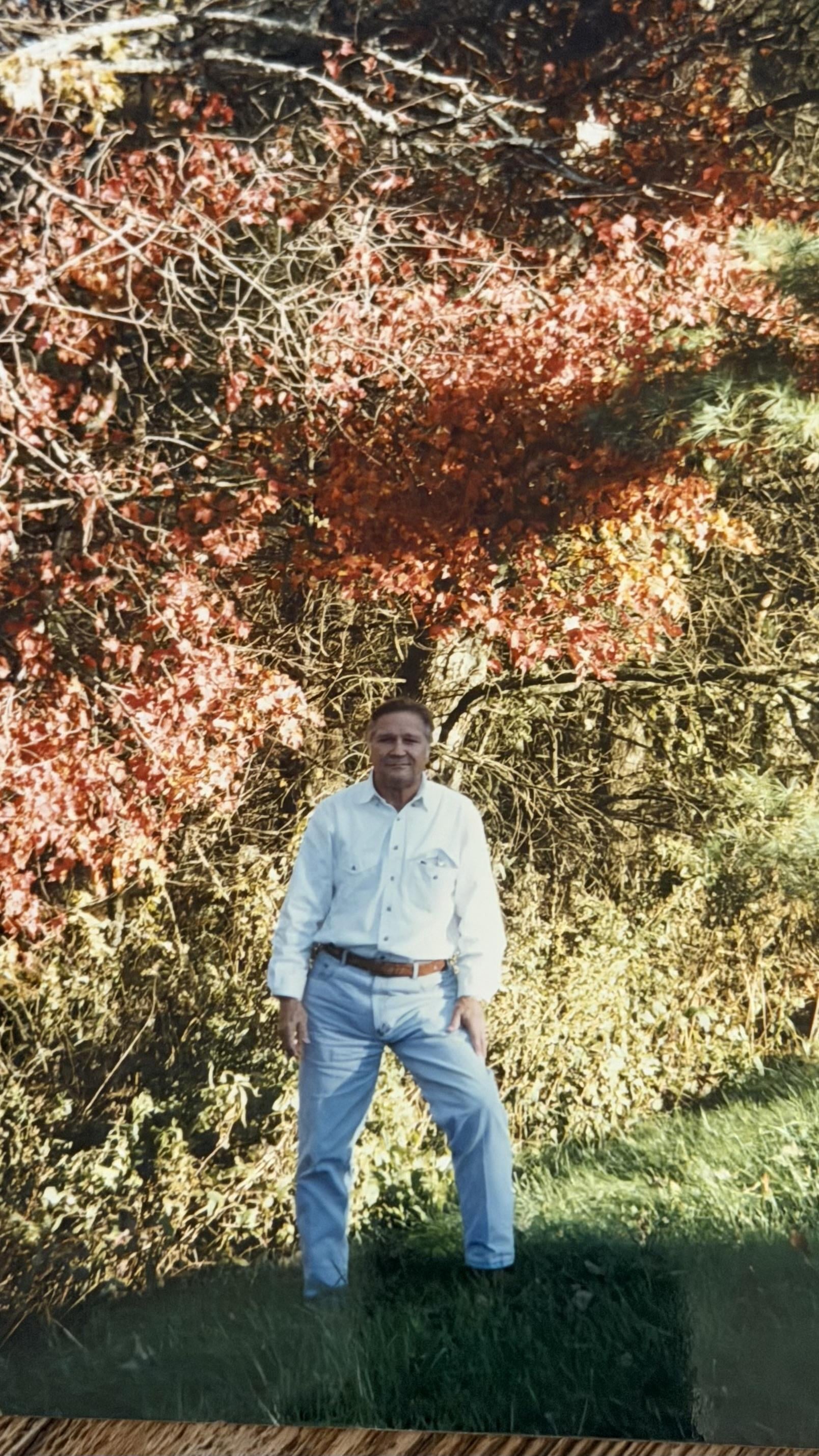 A man standing in front of a tree