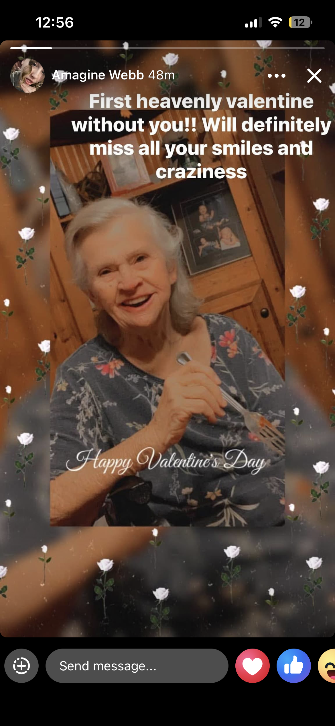 Elderly woman enjoys food while celebrating Valentine’s Day in her home with a warm smile.
