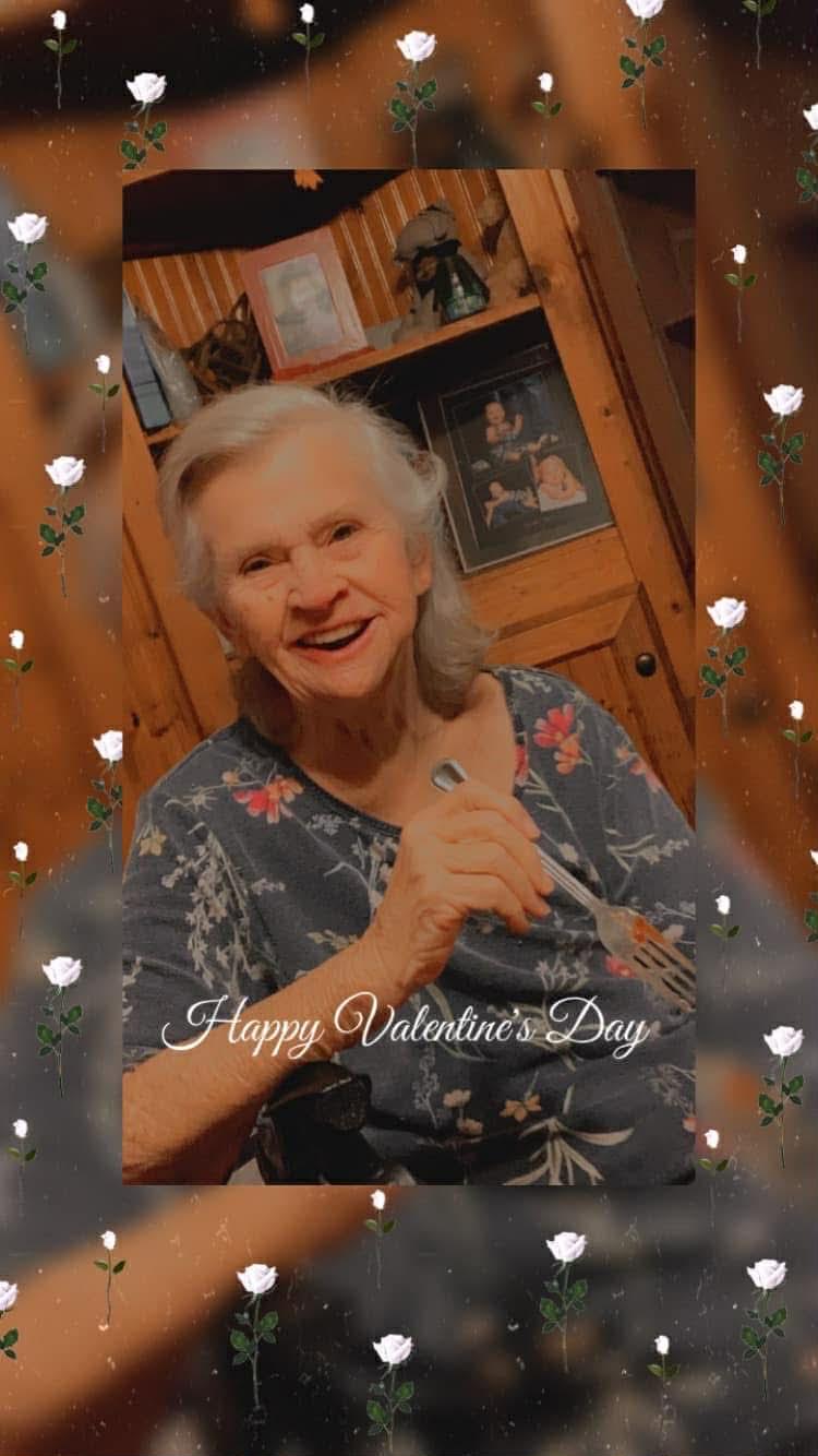 Woman enjoys a meal at home and shares a joyful moment on Valentine's Day with loved ones.