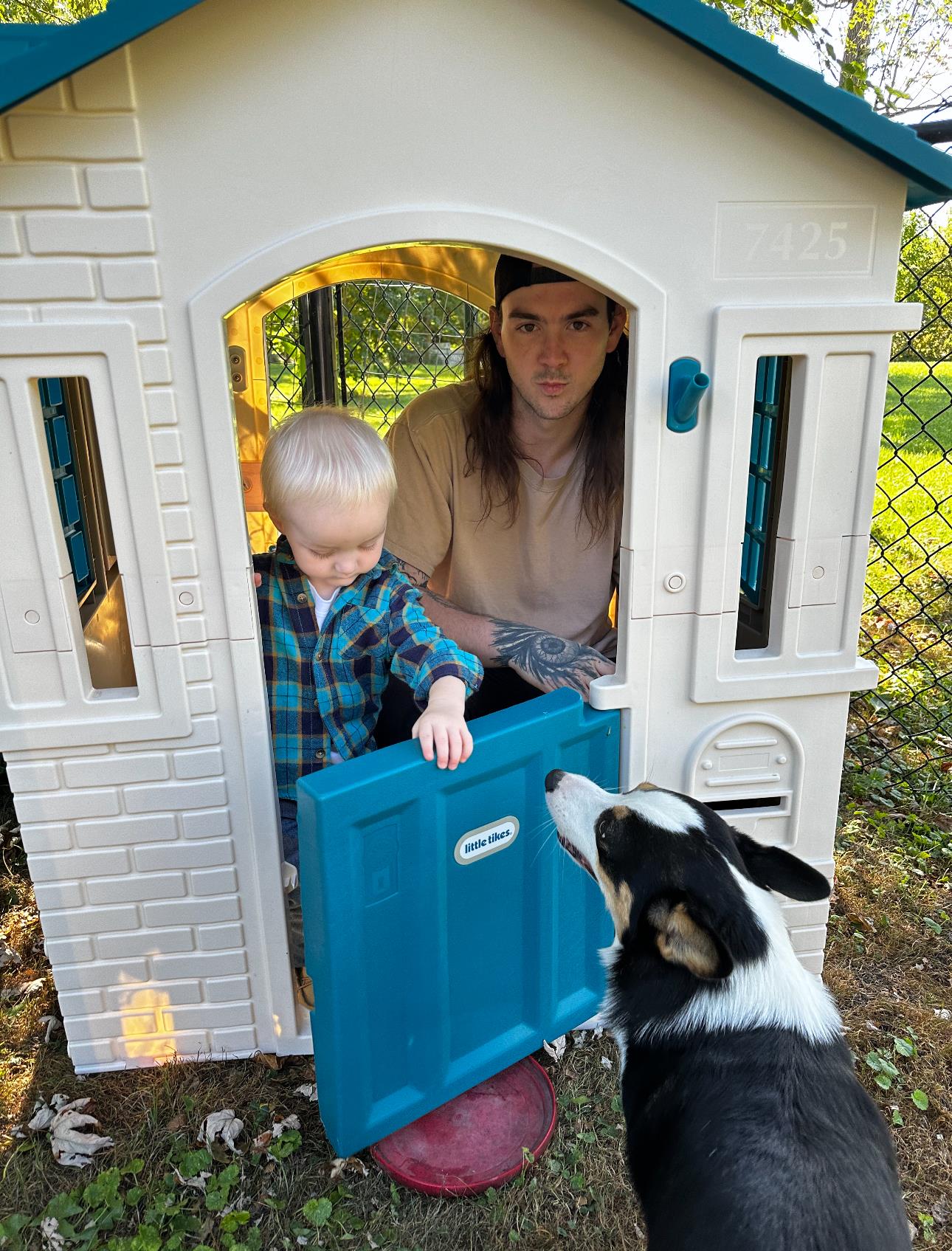 A man and child in a toy house