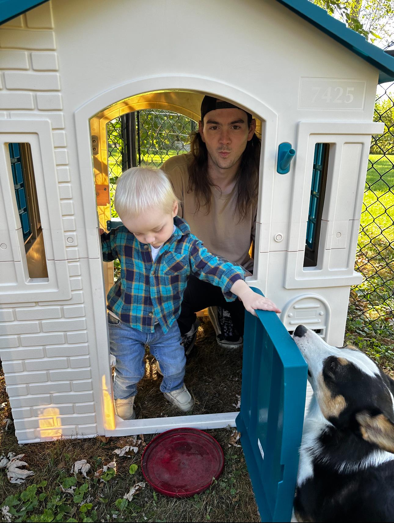 A man and child in a toy house