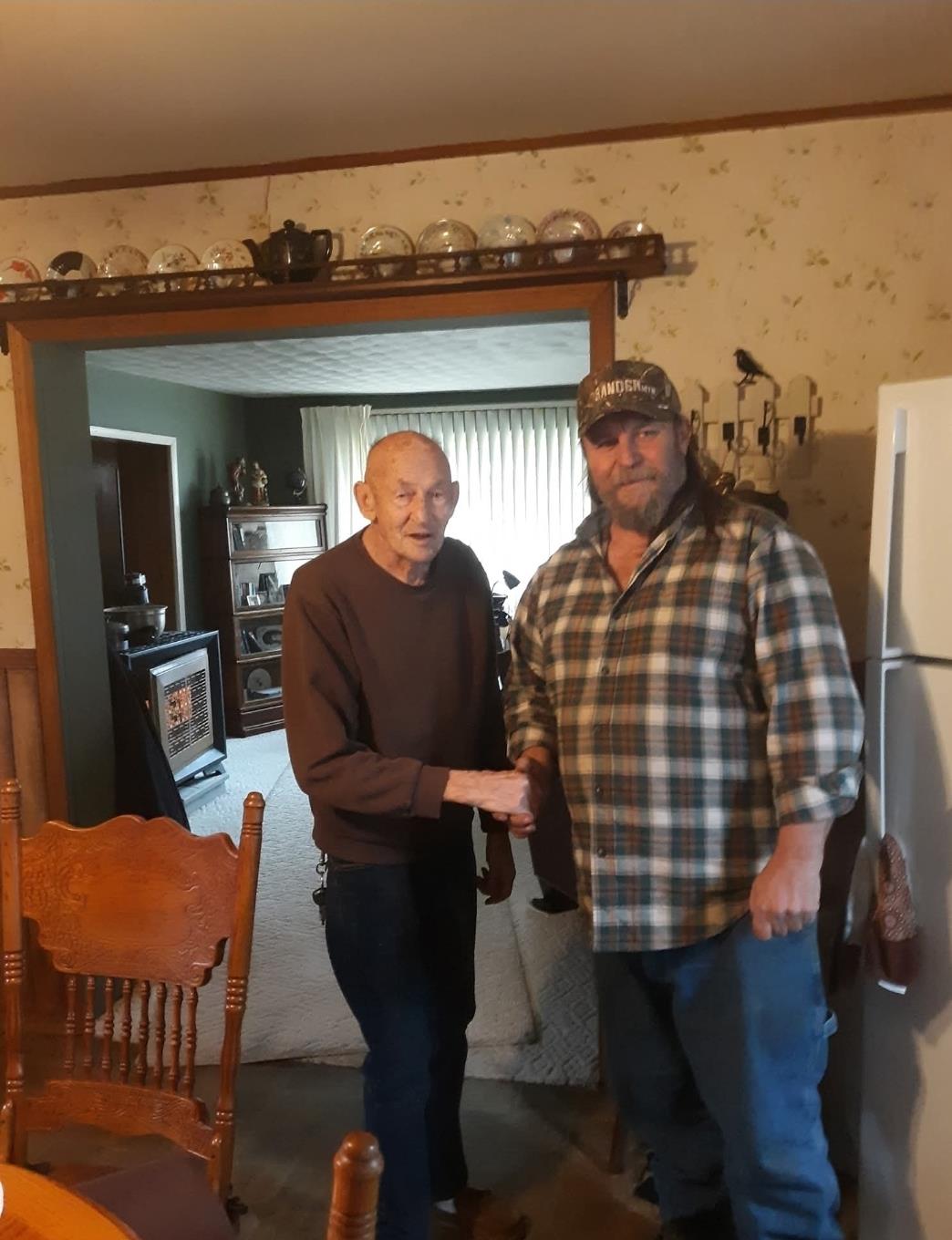 Two men shaking hands in a room
