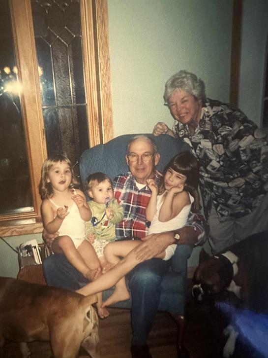 A man and woman sitting on a chair with children