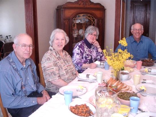 A group of old people sitting at a table