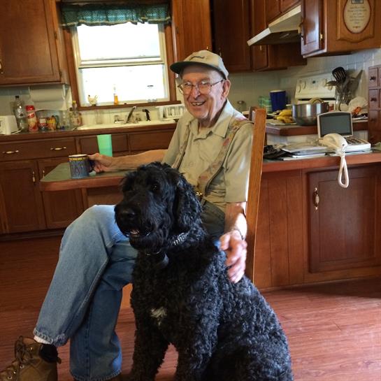 A man sitting in a chair with a dog
