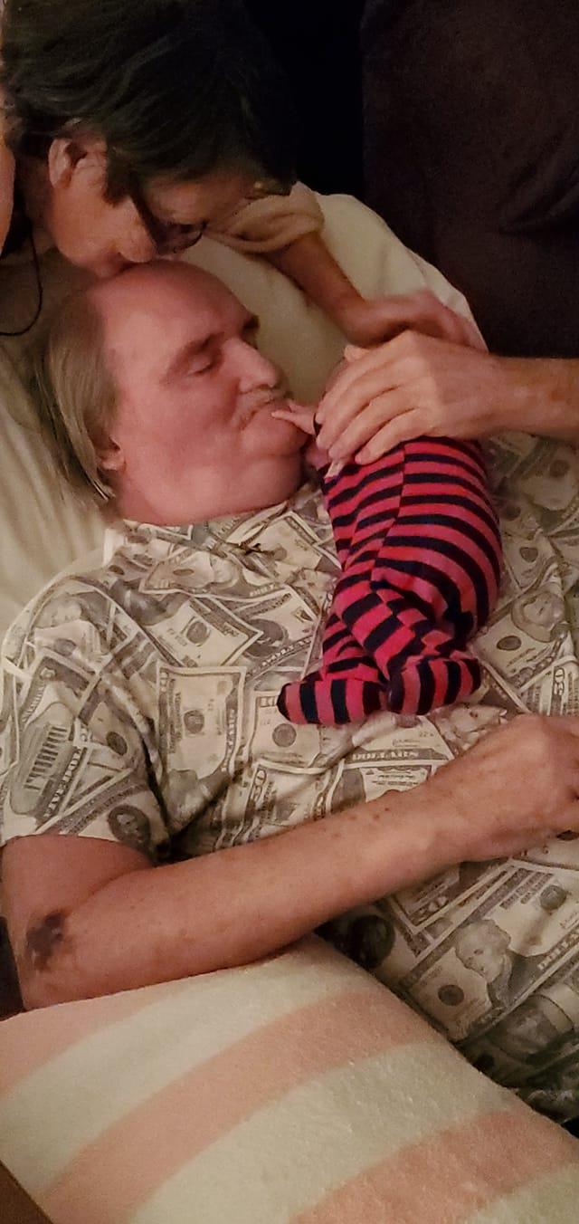 A man lying down with a baby