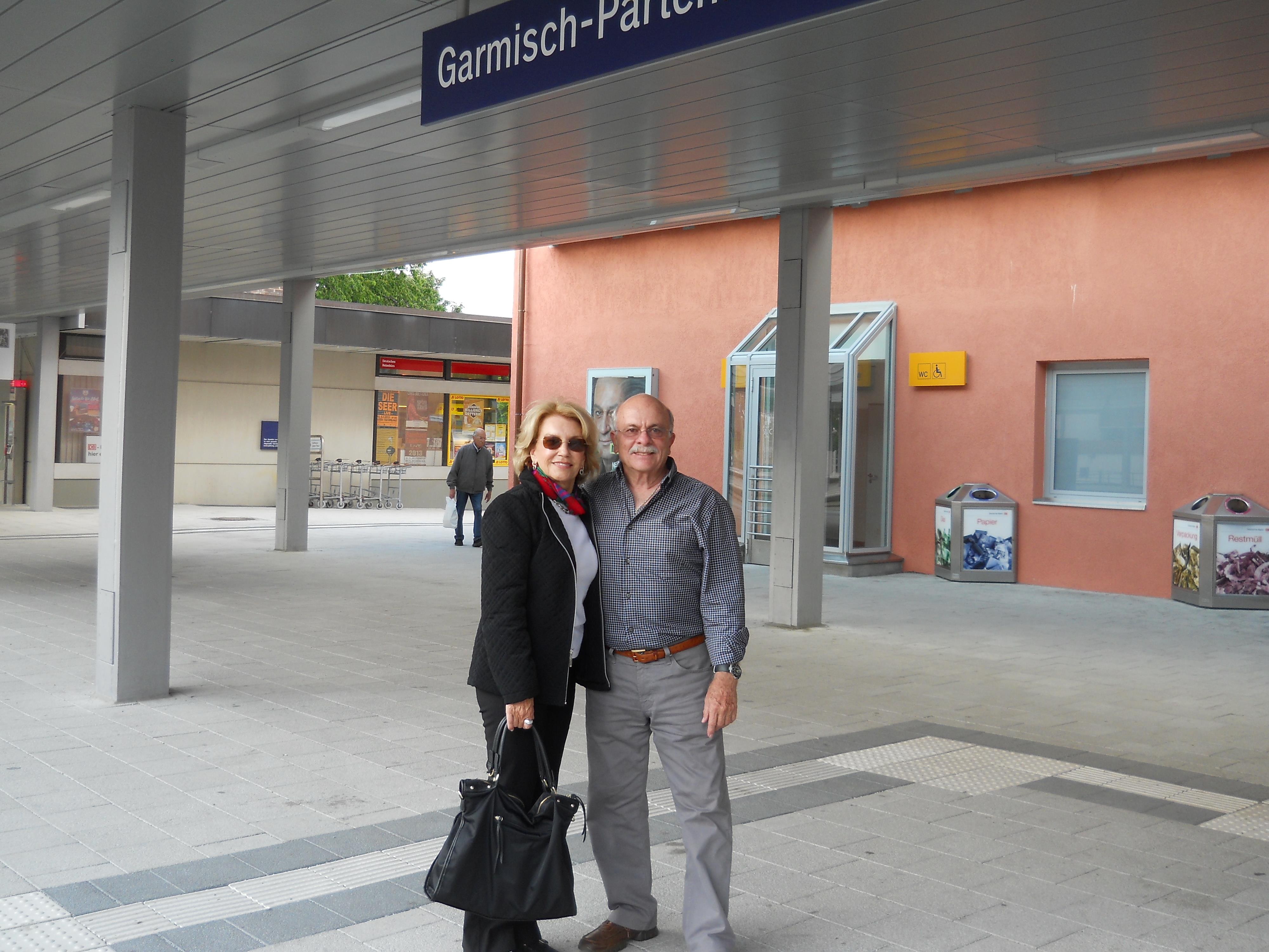 A man and woman standing under a sign