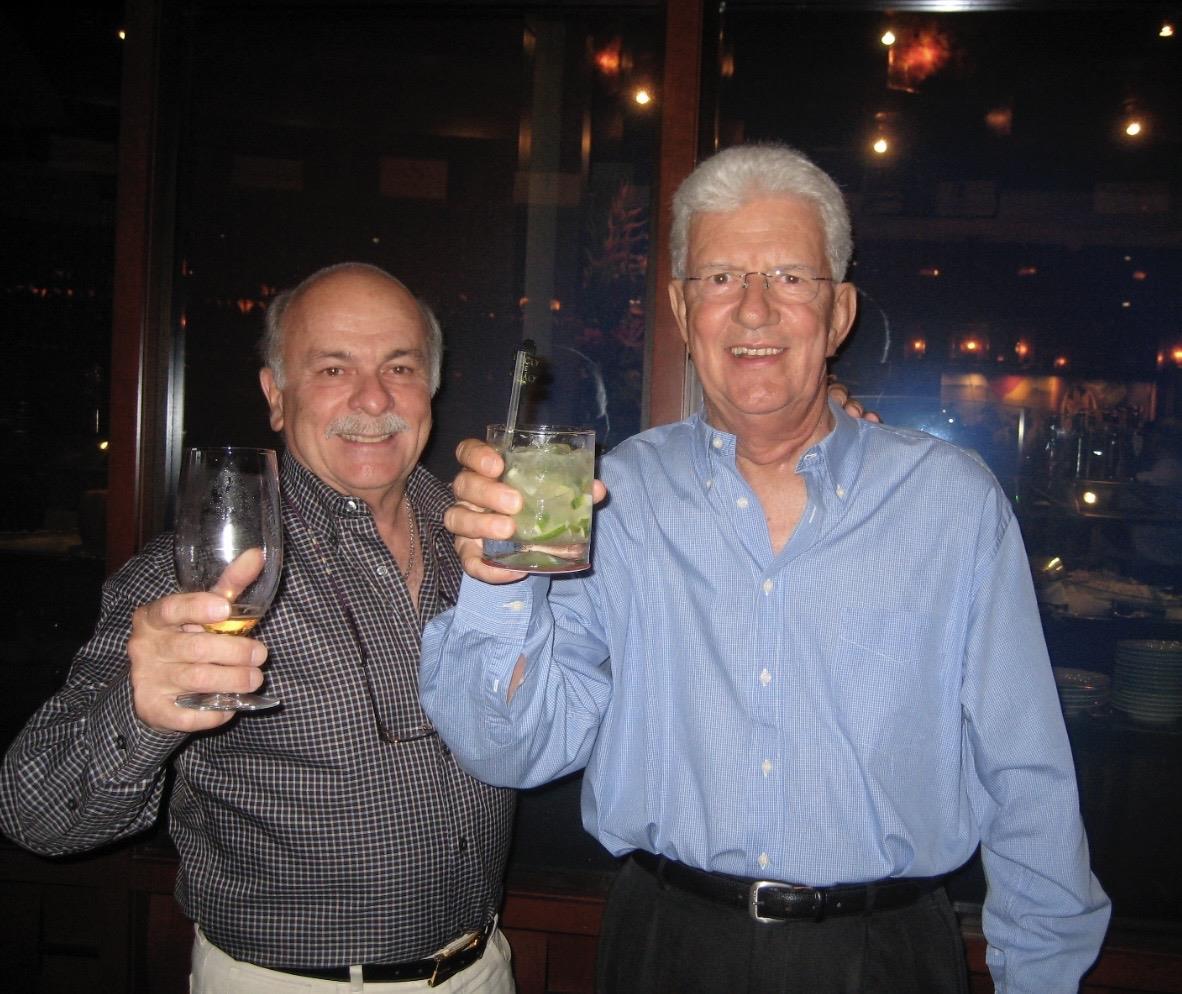 A couple of men holding drinks