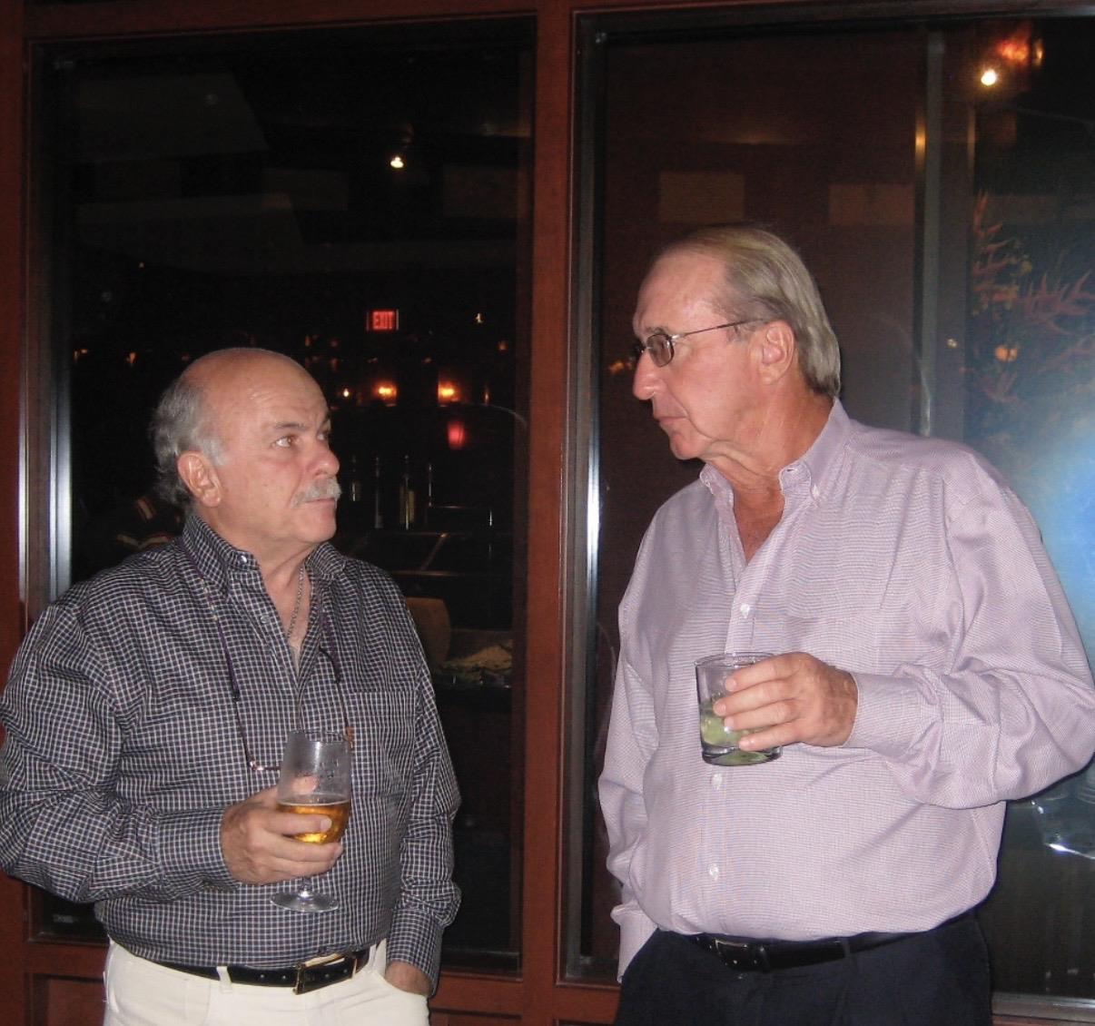 A couple of men holding drinks